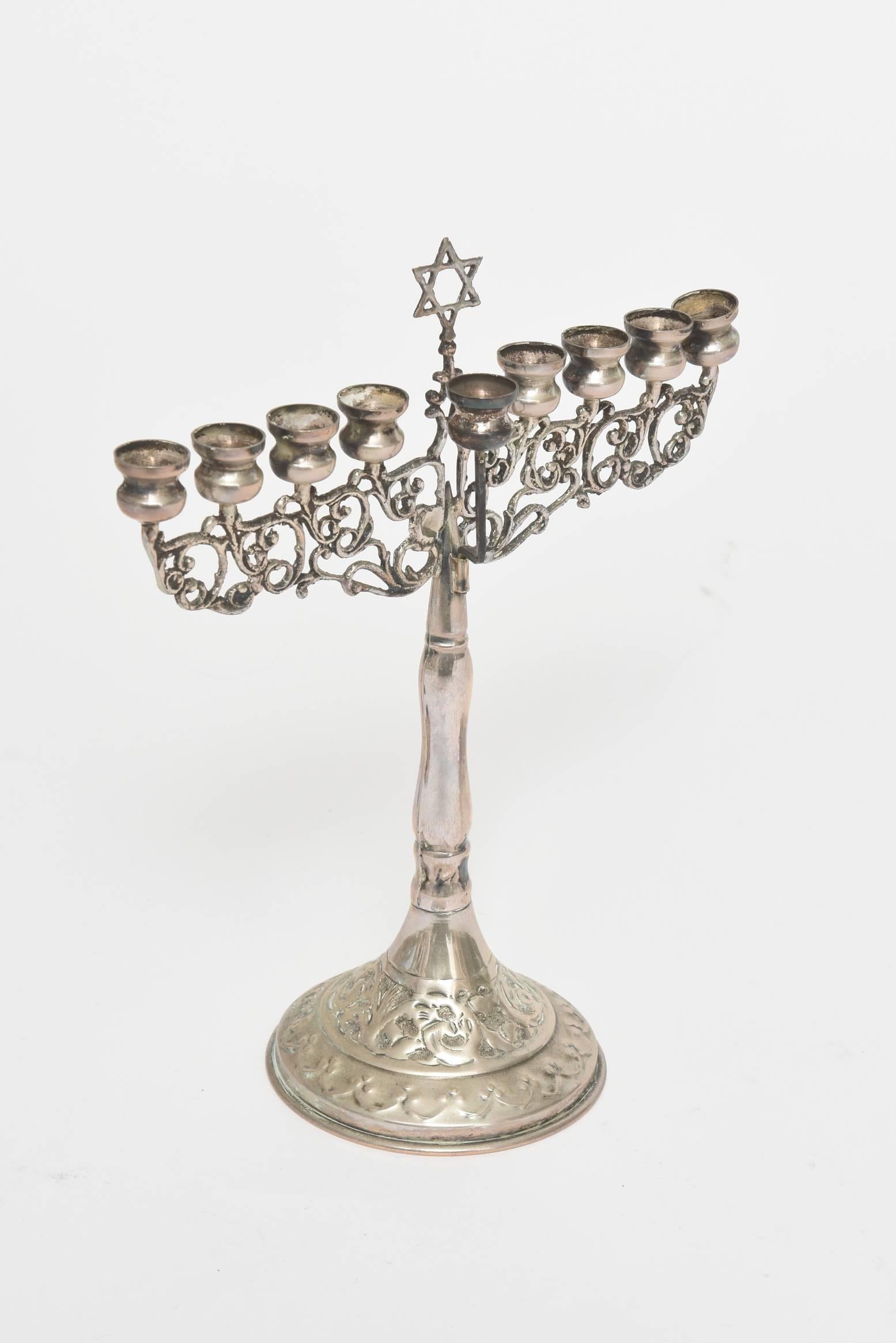 Beautiful raised decoration at base. Open work holding the candles and shamus with a Jewish star at the top. This late 19th century menorah has pierced support for the candles and repouse work on the base. 

Measure: Weight 3.30 troy Oz.
