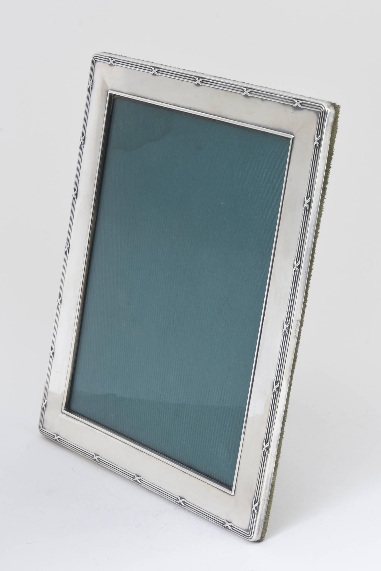 Elegant English picture frame by Carrs of Sheffield featuring a simple border of three lines intersected by an “X”. Wood back covered in green velvet. Holds a photo 8” x 6” photo.
