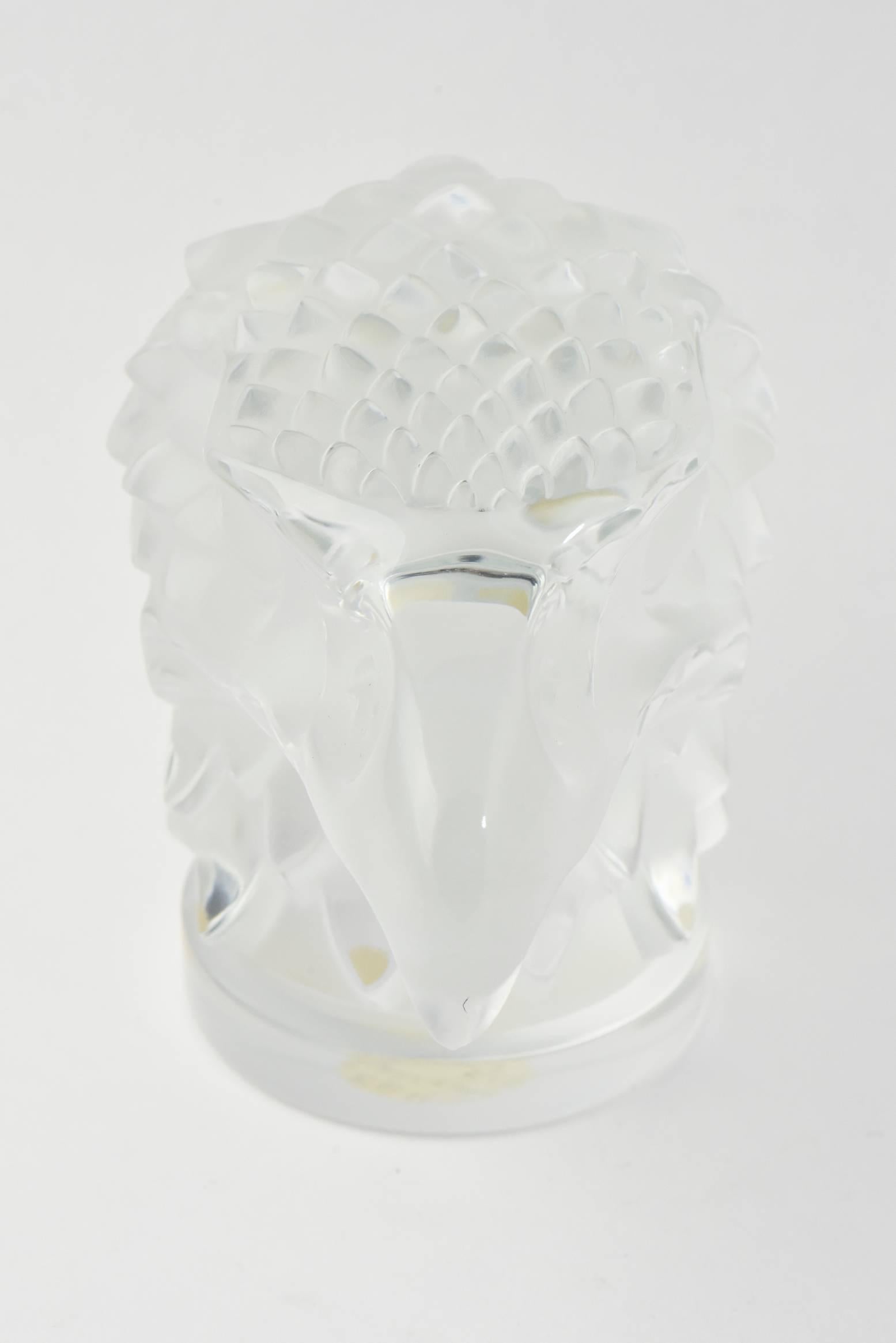 This Lalique Tete d'aigle Eagle head is gracefully crafted out of frosted crystal by Lalique's master glass workers. This design was originally made as a car hood ornament / mascot in the 1920s by Lalique. This piece is from the late 20th century.