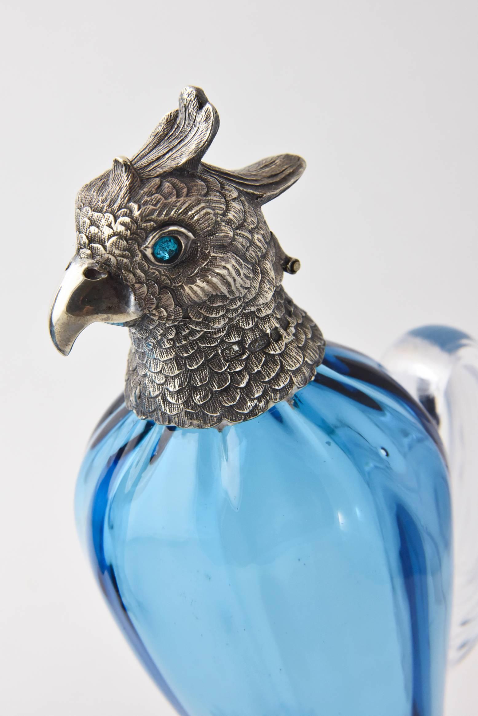 Figural Bird oil and vinegar featuring blue glass bodies with applied sterling silver heads and feet with blue glass eyes.