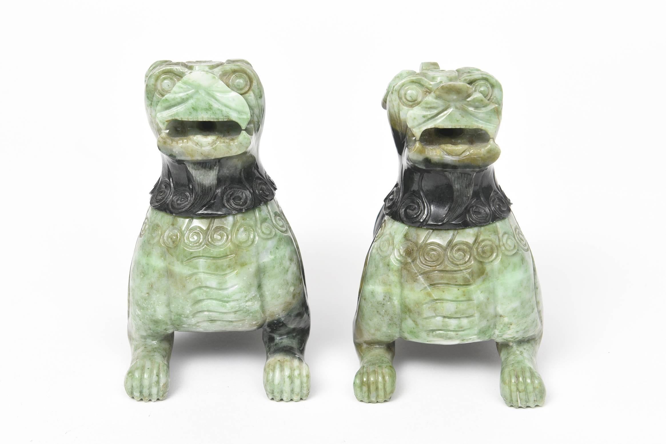 Bi-color green hardstone carved to represent a pair of traditional Chinese foo dogs and lions. The heads of these impressive creatures come off so they can be used as incense burners.