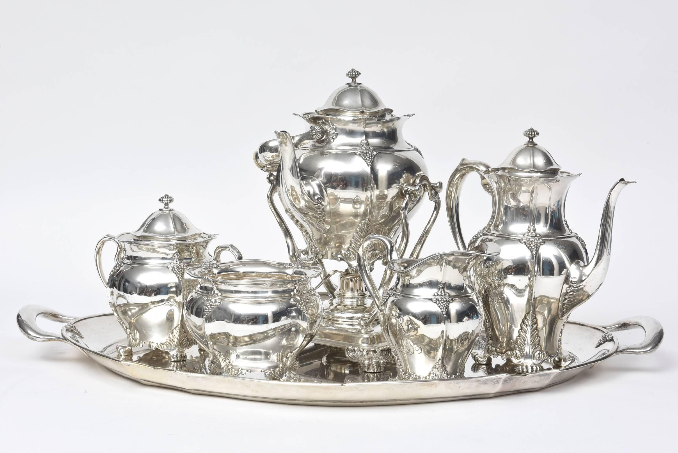 Victorian Tiffany & Co. sterling silver six-piece coffee and tea set. Pattern has applied grapes and vines, fluted edges, and claw feet. Marked: 
