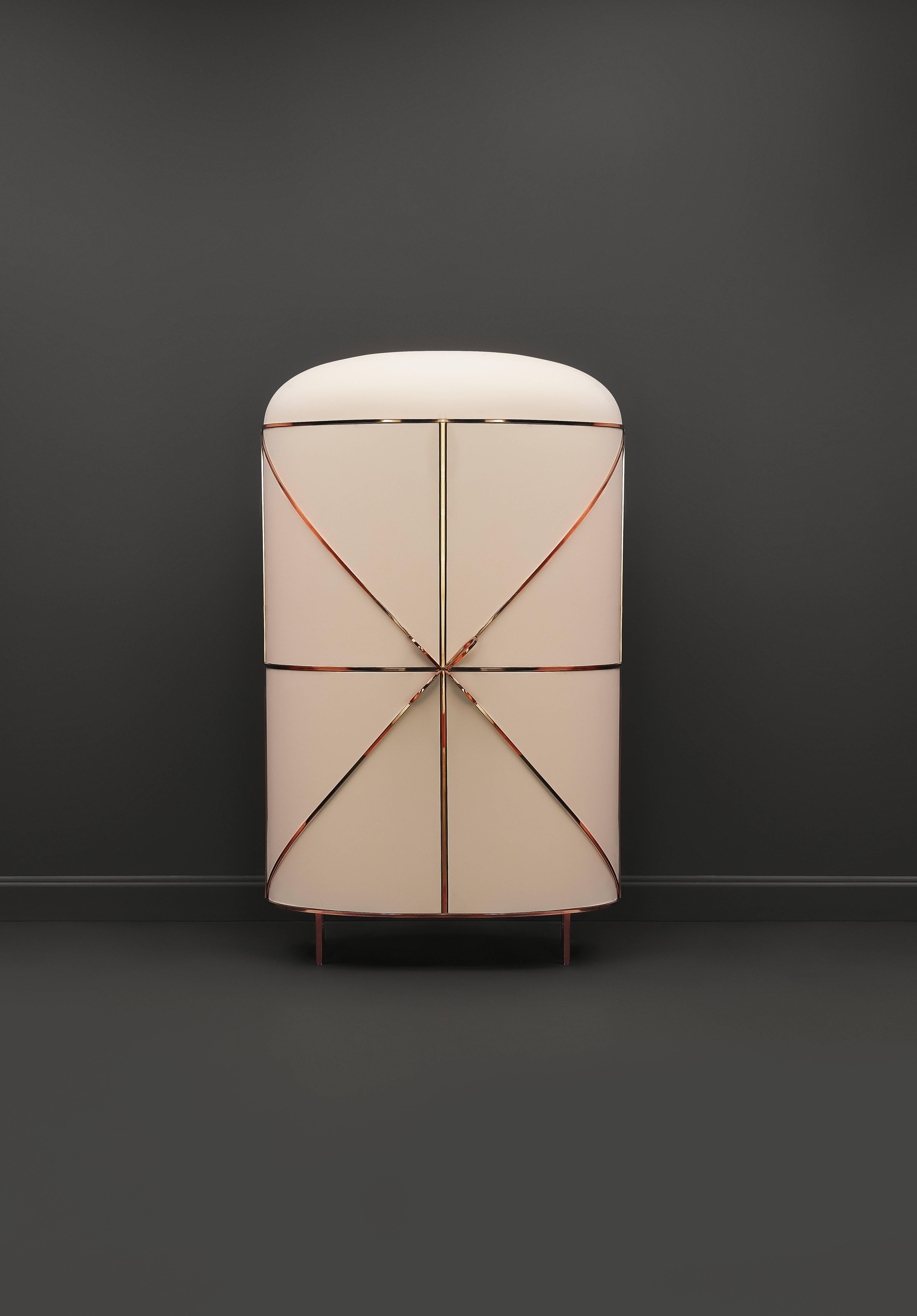 88 Secrets Bar by Nika Zupanc is a bar cabinet inspired by feminine lines with luxurious metal trims in gold or rose gold. 

The piece is handmade in India by Scarlet Splendour, a company founded in 2014 by Ashish Bajoria and Suman Kanodia, siblings