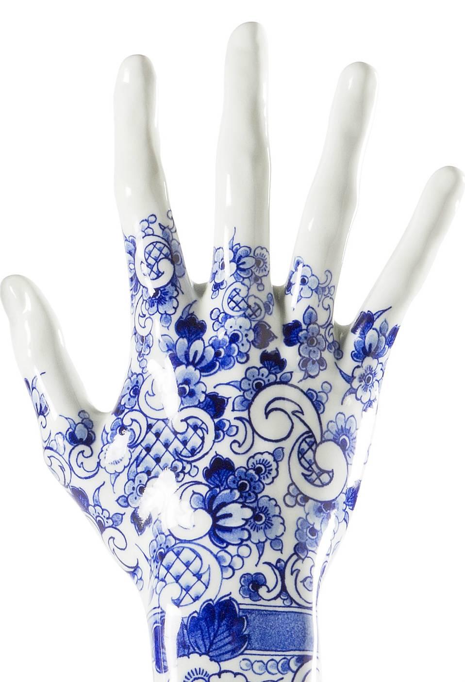 Fragile fingers on a grand piano, 2013. 

In delft blue ink, a symbol of Dutch tradition and beauty, Marcel created a series of experimental porcelain arms, exact copies of the beautiful, renowned pianist Iris Hond’s real arms, through a process