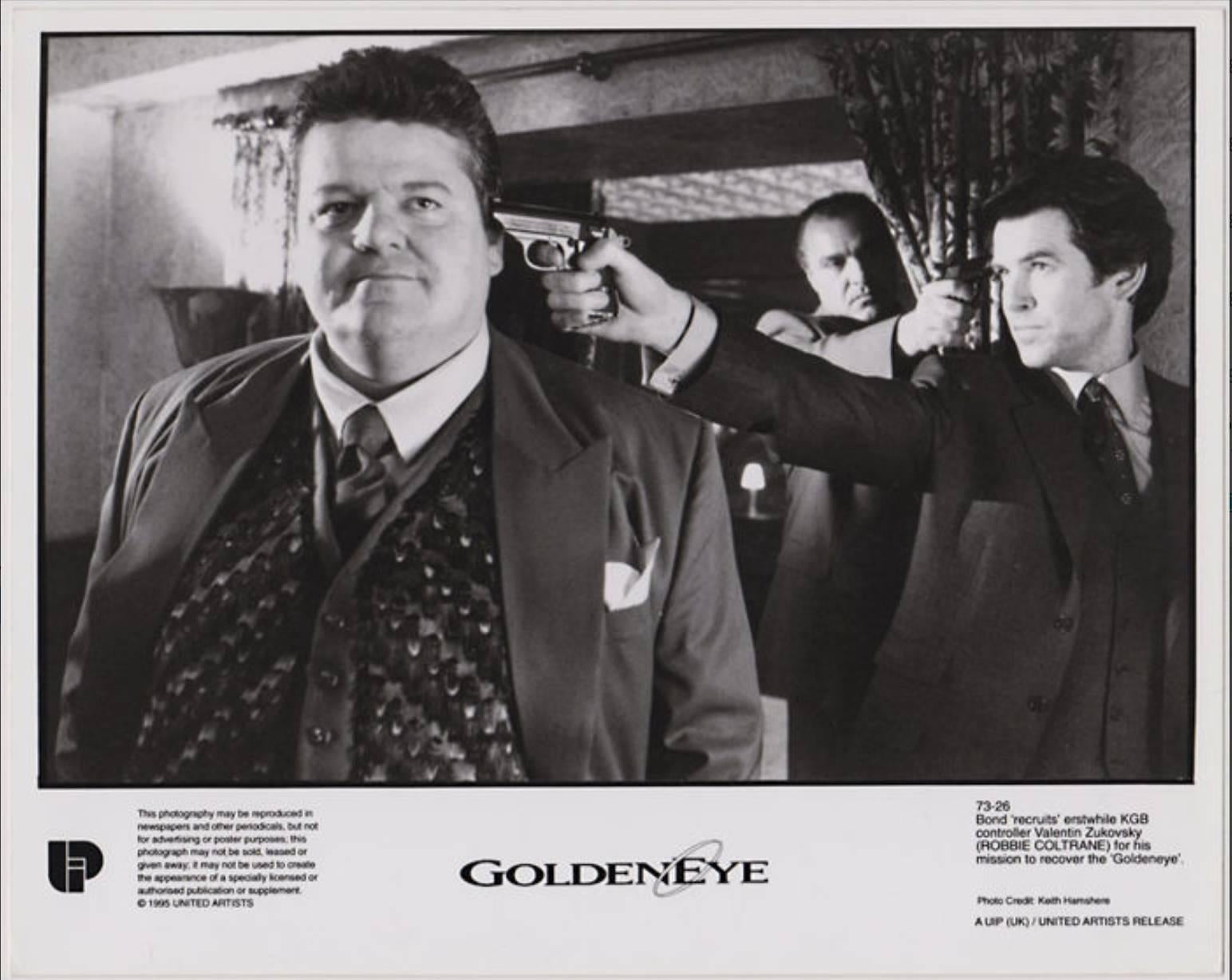 Two original black and white analogue photographs on resin-coated (RC) paper showing Pierce Brosnan, Isabella Scorupco, and Robbie Coltrane in 'Golden Eye' (1995). 

Process: gelatin silver print on resin-coated paper (RC print) 
Size: 25.5cm x