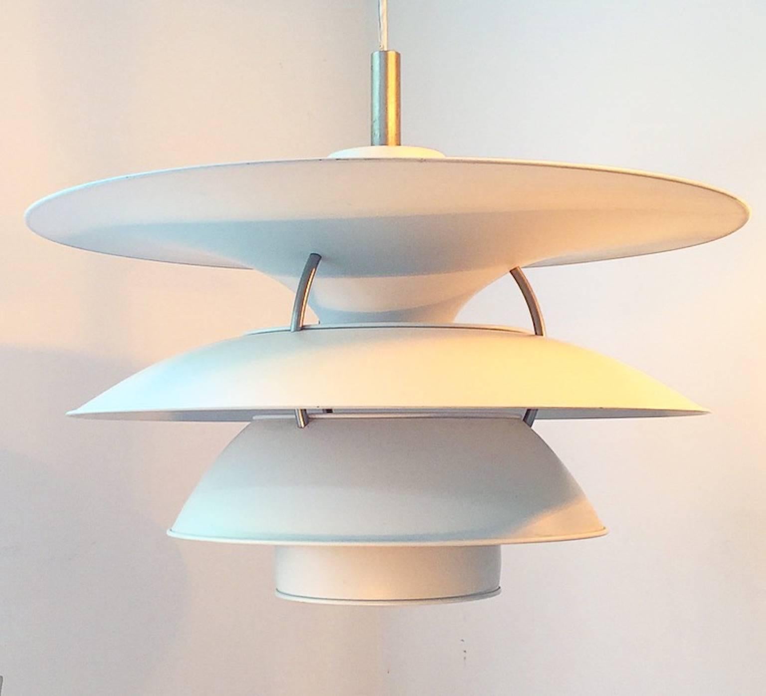 This is the large version of the ceiling lamp designed by Poul Henningensen for the exhibition hall Charlottenborg in Copenhagen in 1979 and manufactured by Louis Poulsen.

The famous shade system PH 6,5 - 6 by Poul Henningsen ensures a beautiful