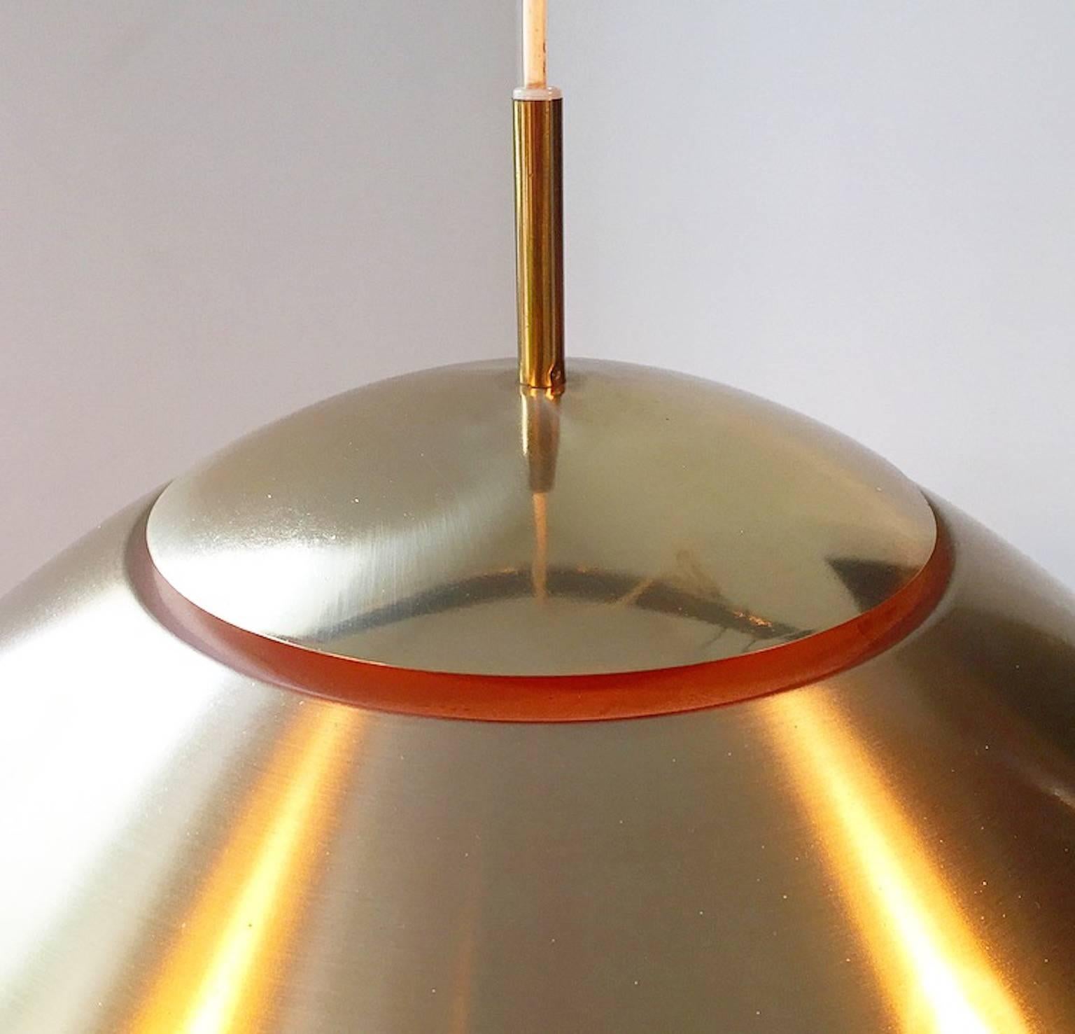 Classic Mid-Century ceiling light by Vilhelm Vohlert for Nordisk Solar company of Denmark mid-1960s.

The light consists of a large brass shade divided in two with orange details. Comes with the original diffuser.

Ideal for the modern