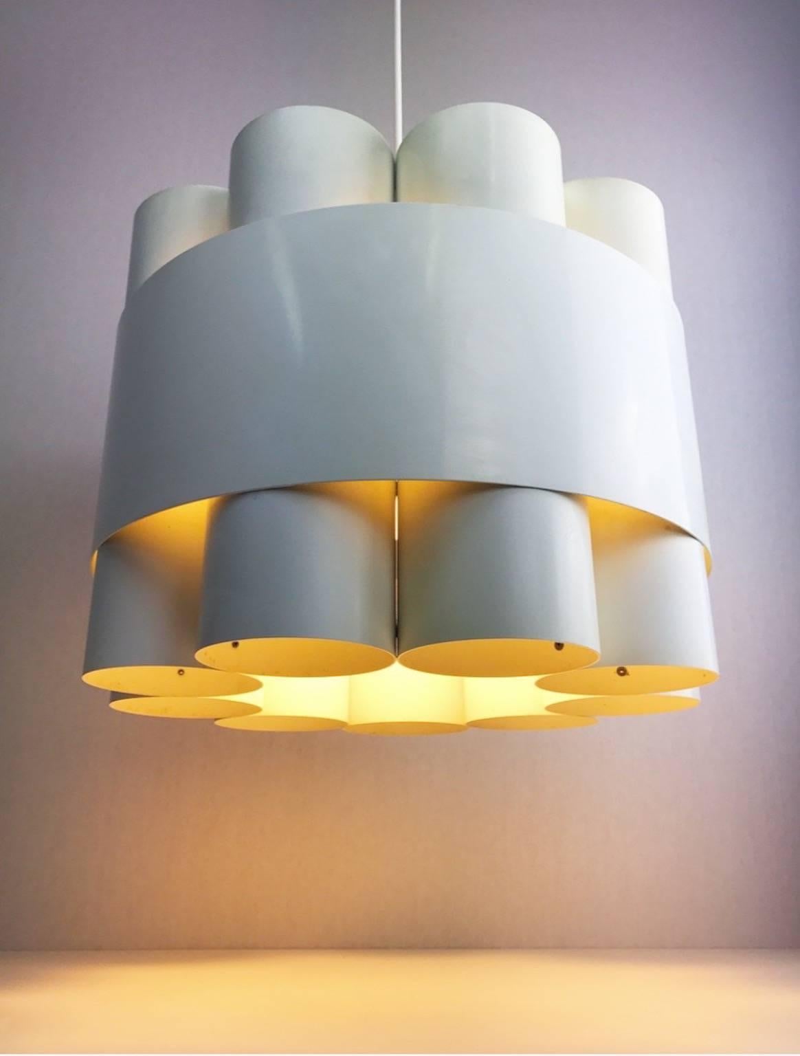 A very rare design piece from 1972 designed by Danish Jo Hammerborg for Fog & Mørup.

This contemporary and Minimalist chandelier combines functionality with aesthetics which makes this an unique eye-catcher. 

Nine white lacquered metal tubes