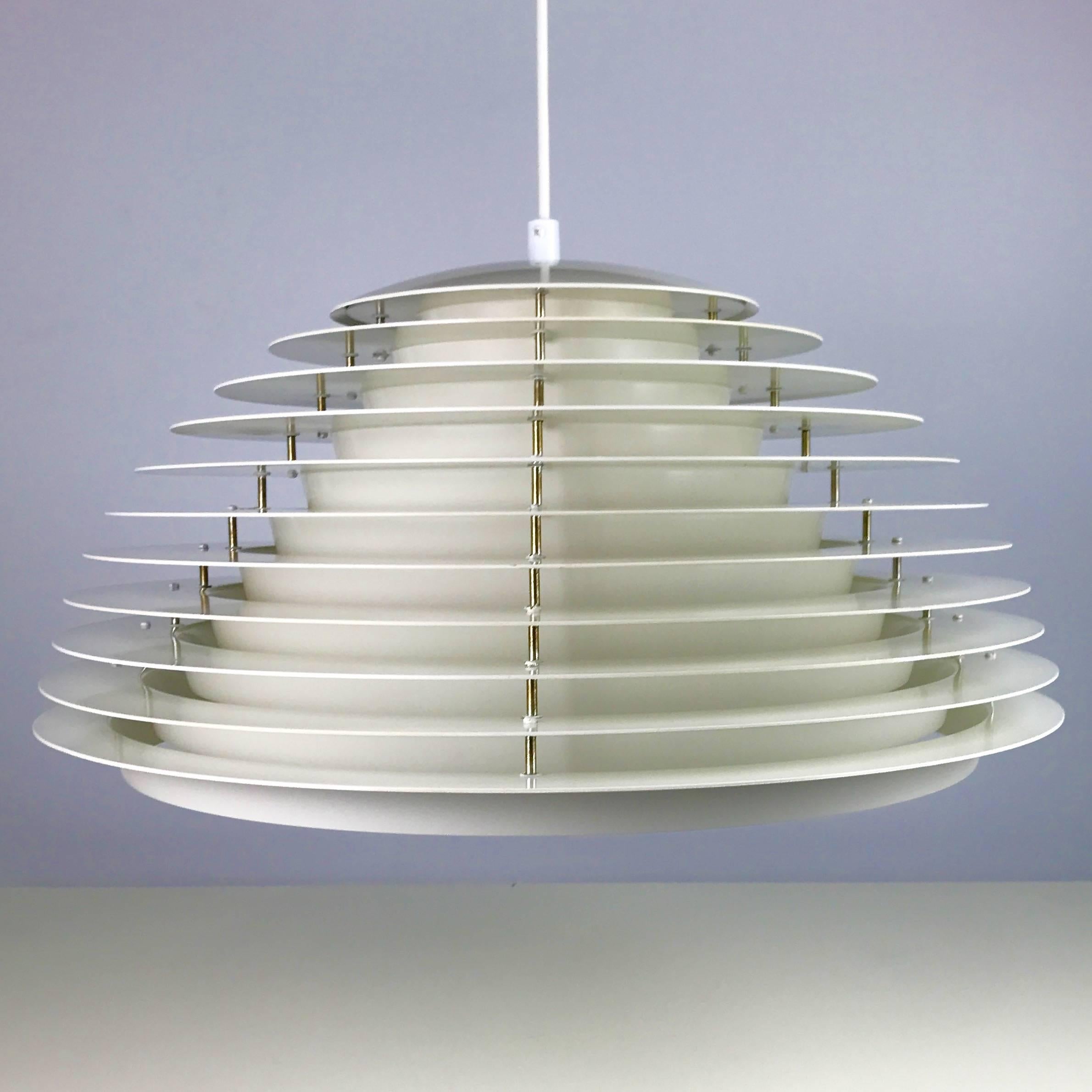 When you combine magnificent craftsmanship and brilliant design you might end up with something like this beauty, the impressive Hekla.

The light consists of ten white lacquered shades with a curved white lacquered lid on top. The light is heavy