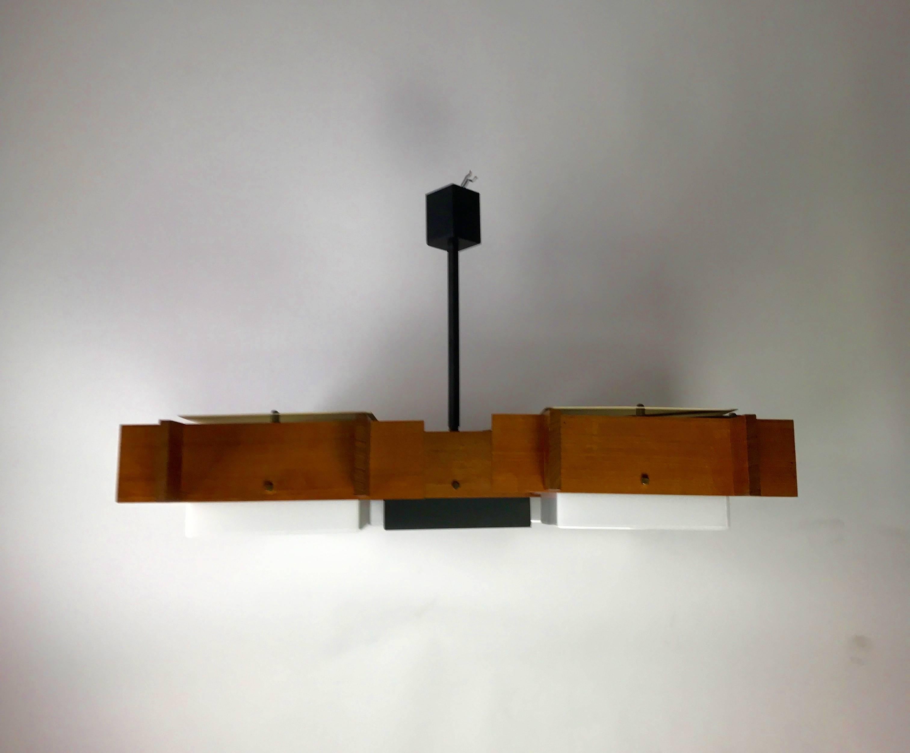 Very rare ceiling pendant Esperia by Angelo Brotto and Oscar Torlasco, 1950s. 

Four white acrylic light corners with a black lacquered inner piece all constructed around a beautiful crafted teak shell. Beautiful brass knobs holds the inserted