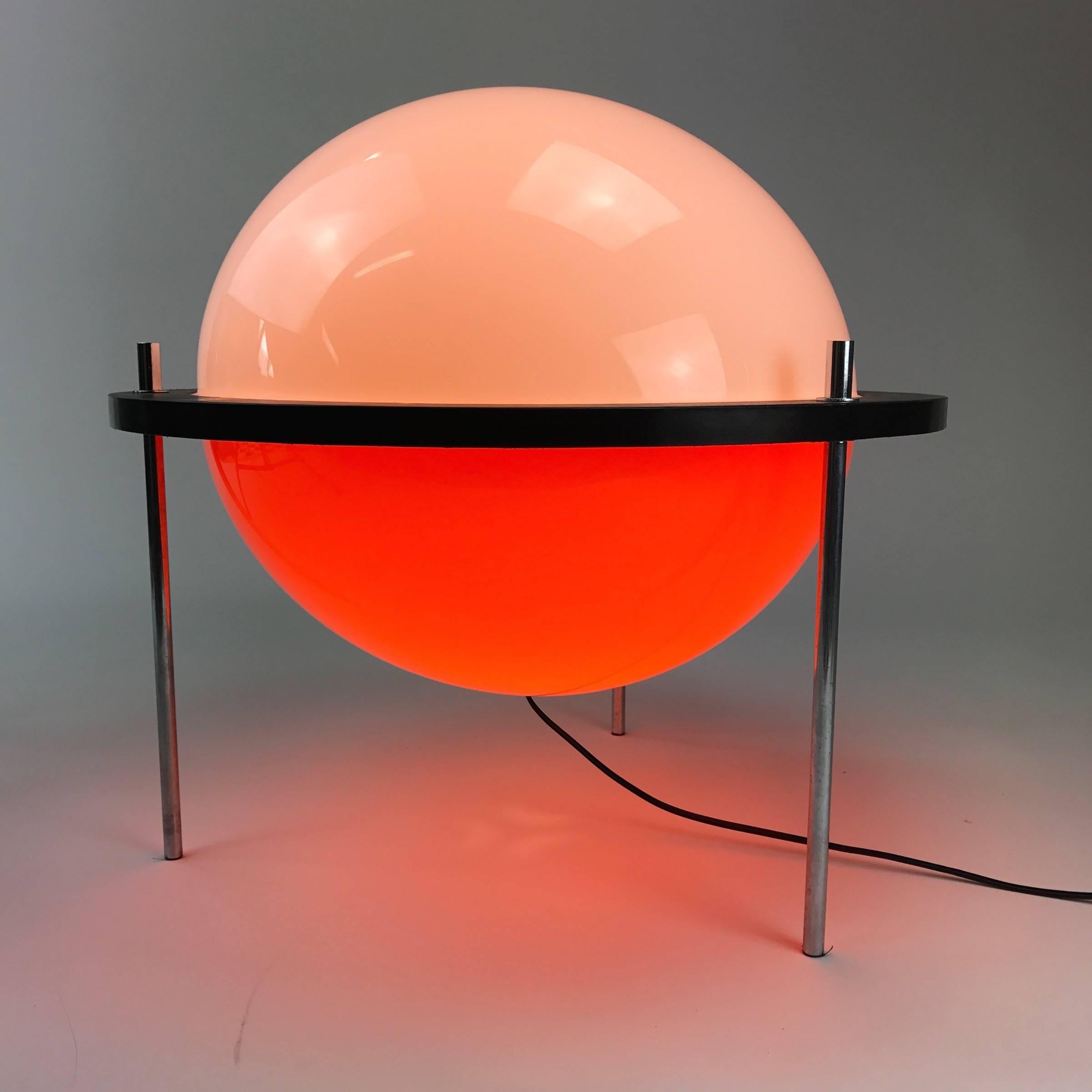 Very large globe shaped floor lamp by Harvey Guzzini, Italy. 

Rare piece of Italian Space Age design made of two large plastic half spherical pieces. The black centrepiece is made of black lacquered wood. Three chrome rods makes out the stand.
