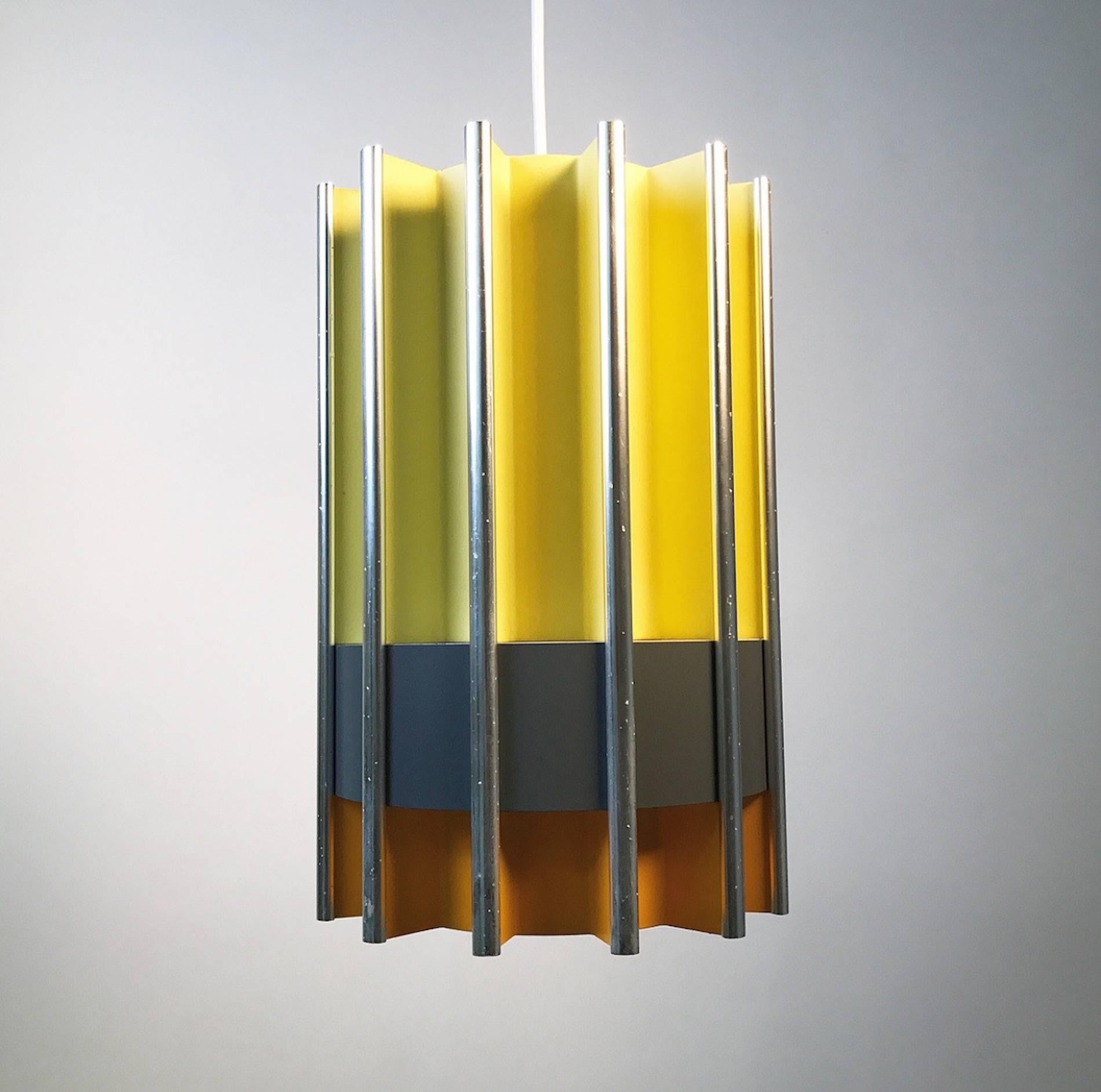 The rare Pantre by Bent Karlby for Lyfa, mid-1960s, Denmark. 

Sections of orange and yellow lacquered parts divided with a grey belt of lighting shining through the sides. Light is also distributed up and down wards.

All the pieces are put