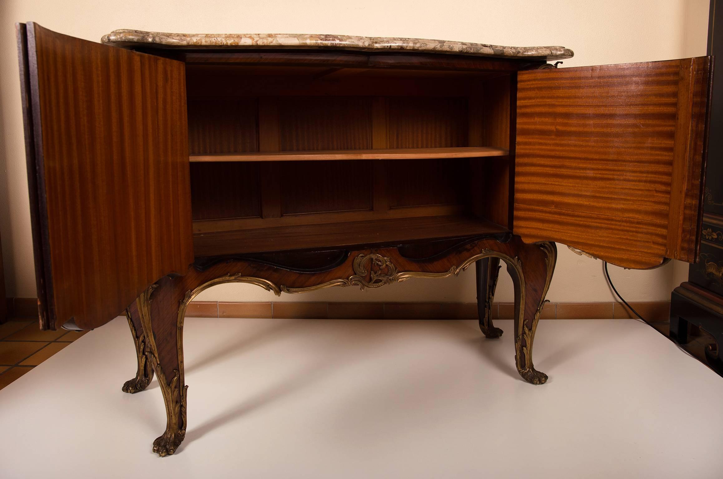 Two-door cabinet with flower marquetry and a breche violette profiled marble top. Elaborate bronze ornamentation in the Louis XV style, France Belle Époque, circa 1920. The interior in mahogany, with a later added or replaced shelf. On four bronze