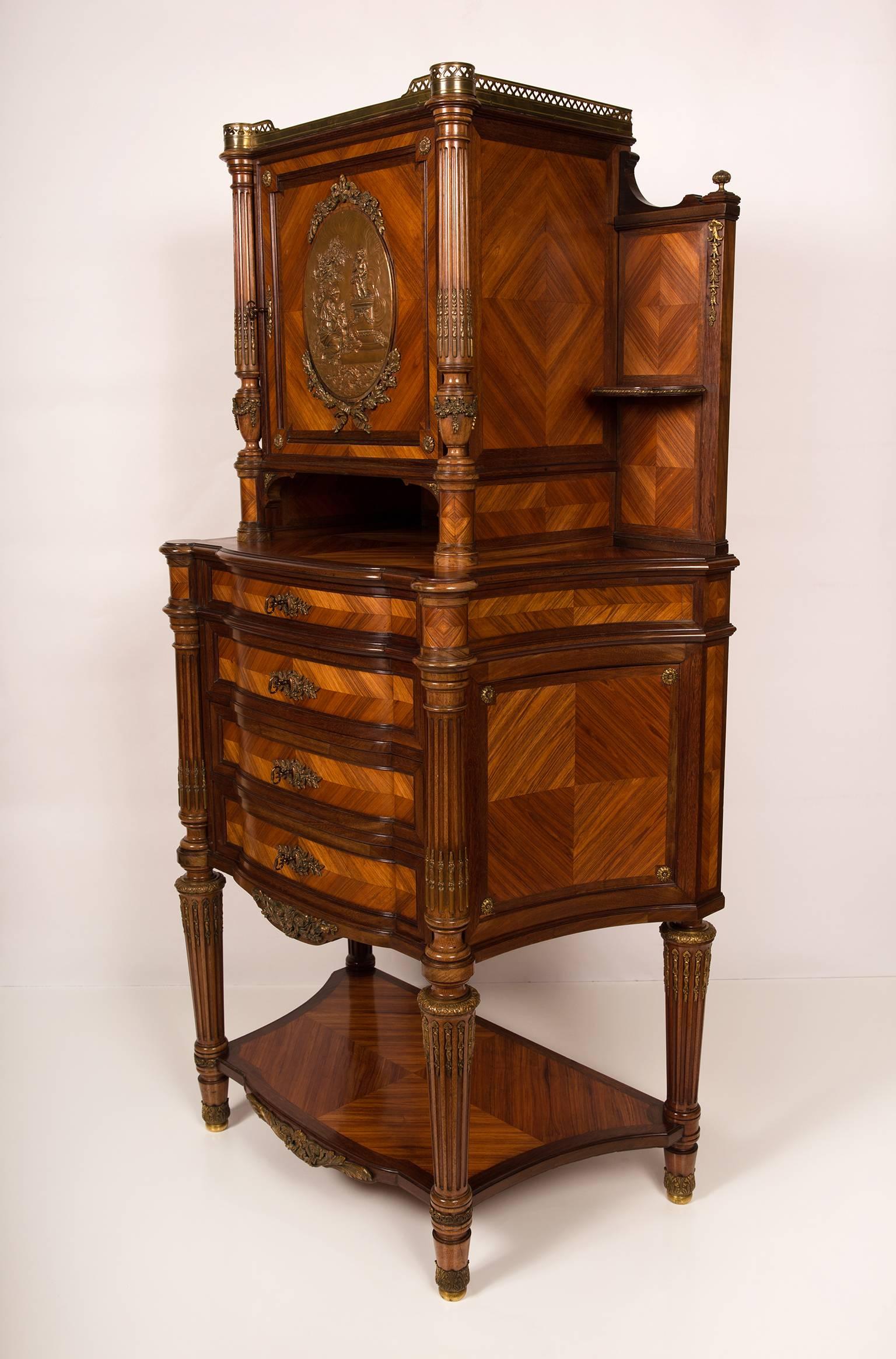 Nice quality cabinet with one door, four drawers and etageres on the sides. Veneered tulipwood and kingwood on a mahogany interior. Richly adorned with bronze ornaments and in the centre of the door an oval bronze plaque. This plaque is finely