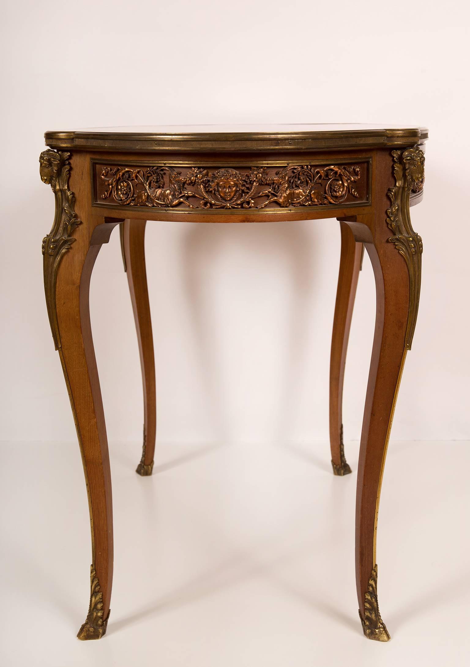 Oval center table with drawer in the Louis XVI, Transitional style. Mahogany with parquetery inlay on the top and fine bronze mounts. The table is stamped in the drawer and it has a metal tag with signature of the manufacturer: Haentges Freres,