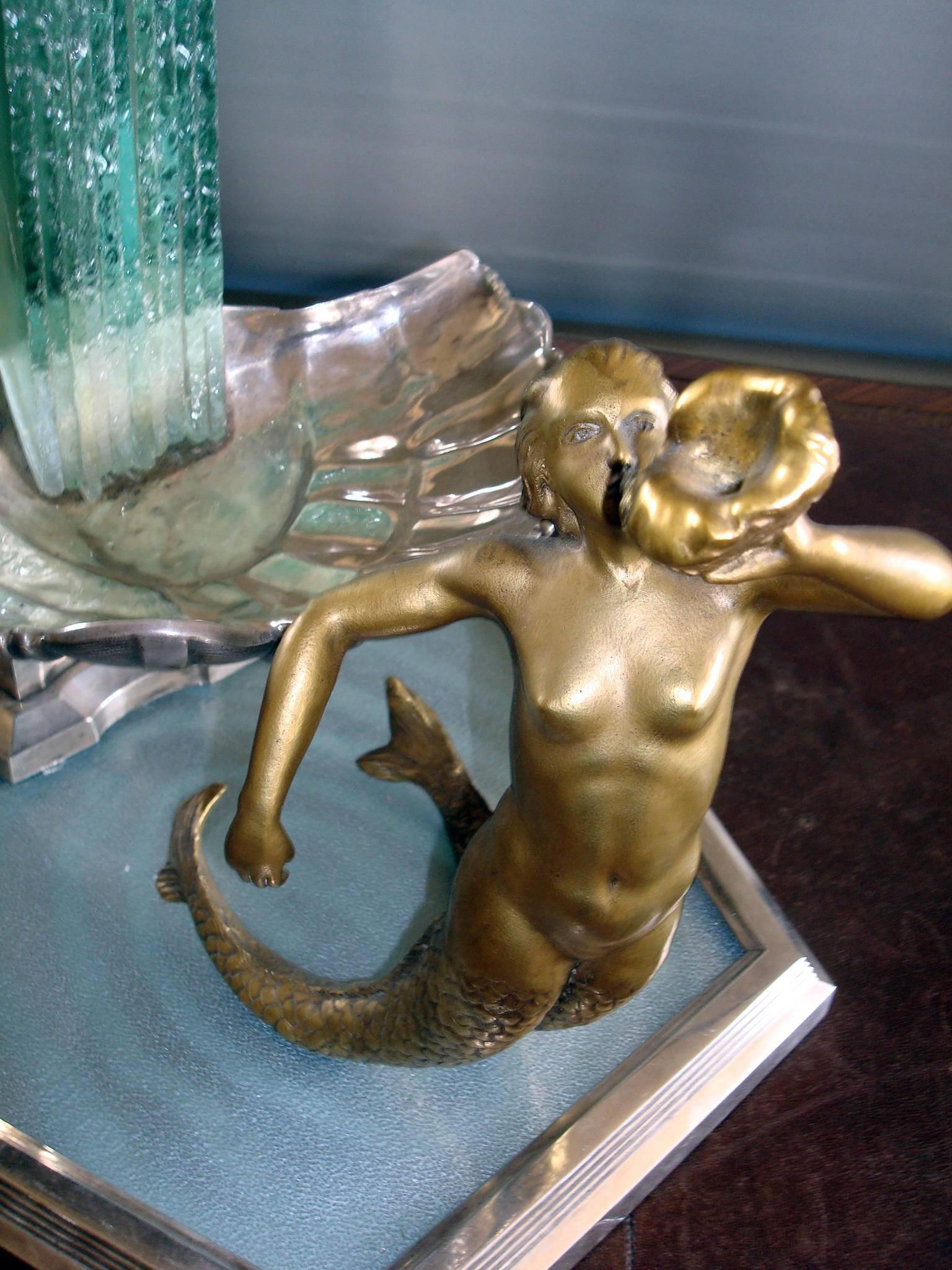 Spectacular and original French Art Deco centrepiece with electric light, representing a water fountain. Two mermaids, one blowing a sea shell Horn and the other holding a trident, each attached to a shell which can contain fruits, flowers or