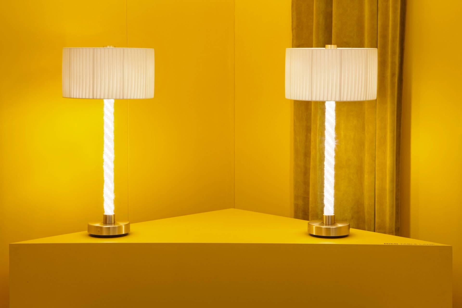 The Mico table lamp belongs to the Mico series that explores the concept and experience of pure light, personifying Baroncelli’s commitment to progressive design and exceptional craftsmanship. 

The framework is bound by strands of cristallo glass