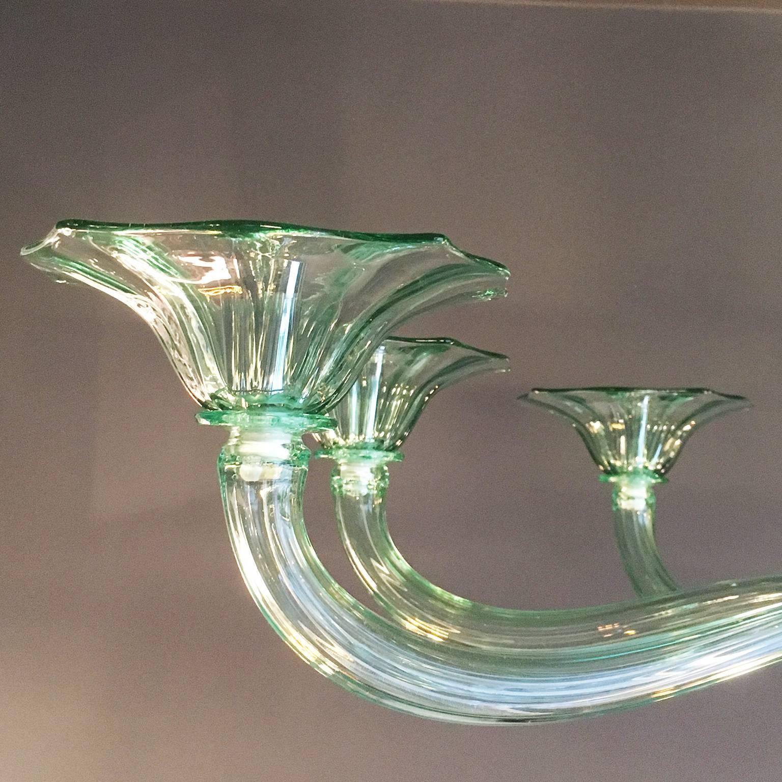 Handblown Murano glass eight-arm chandelier with straight ribbing finish and hand pulled cup edges in pale green glass.
Eight x E14 bulb fitting.
 
