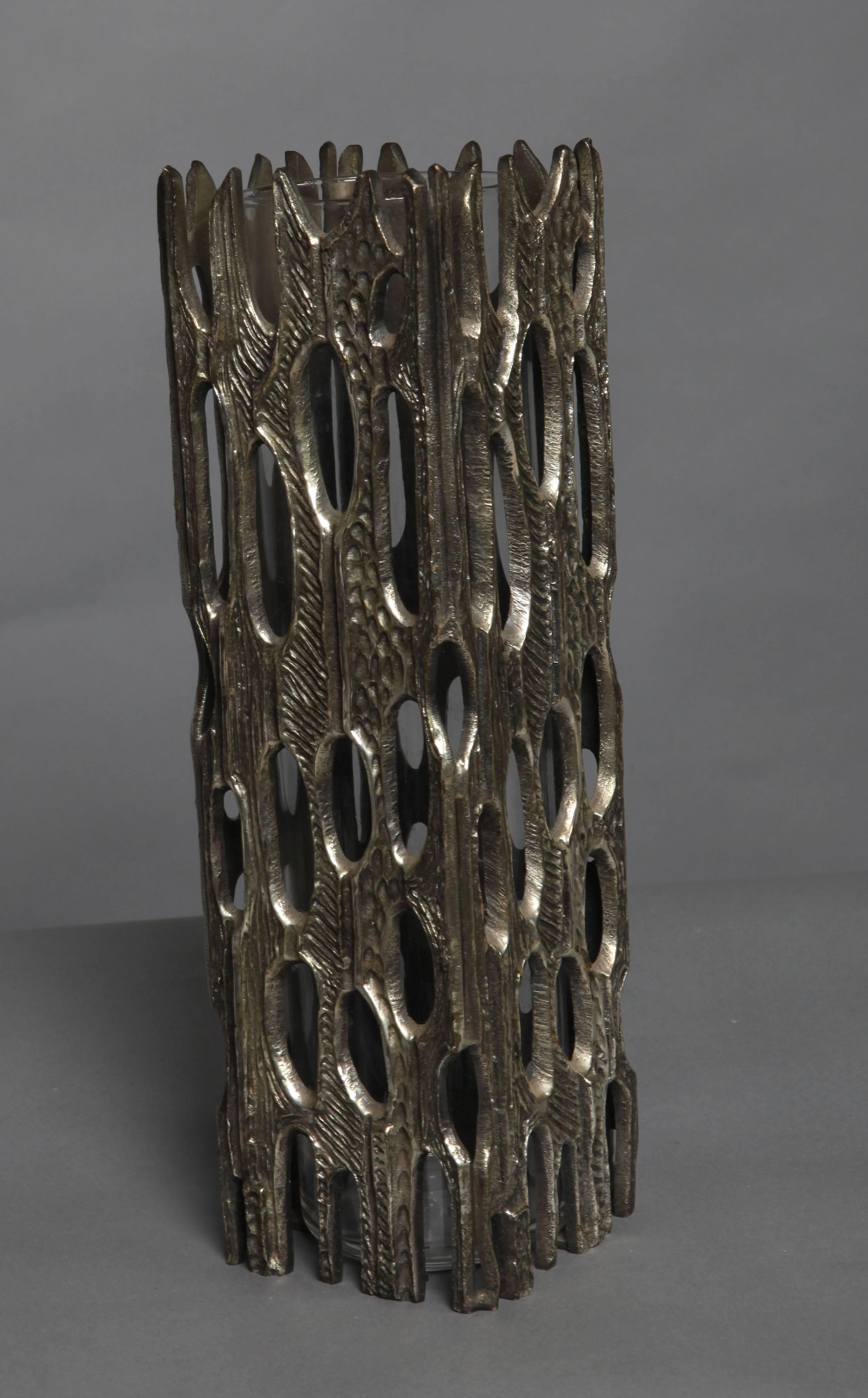 A stunning vase in neo-Gothic style in bronze with nickel patina with an encased glass vase.
    