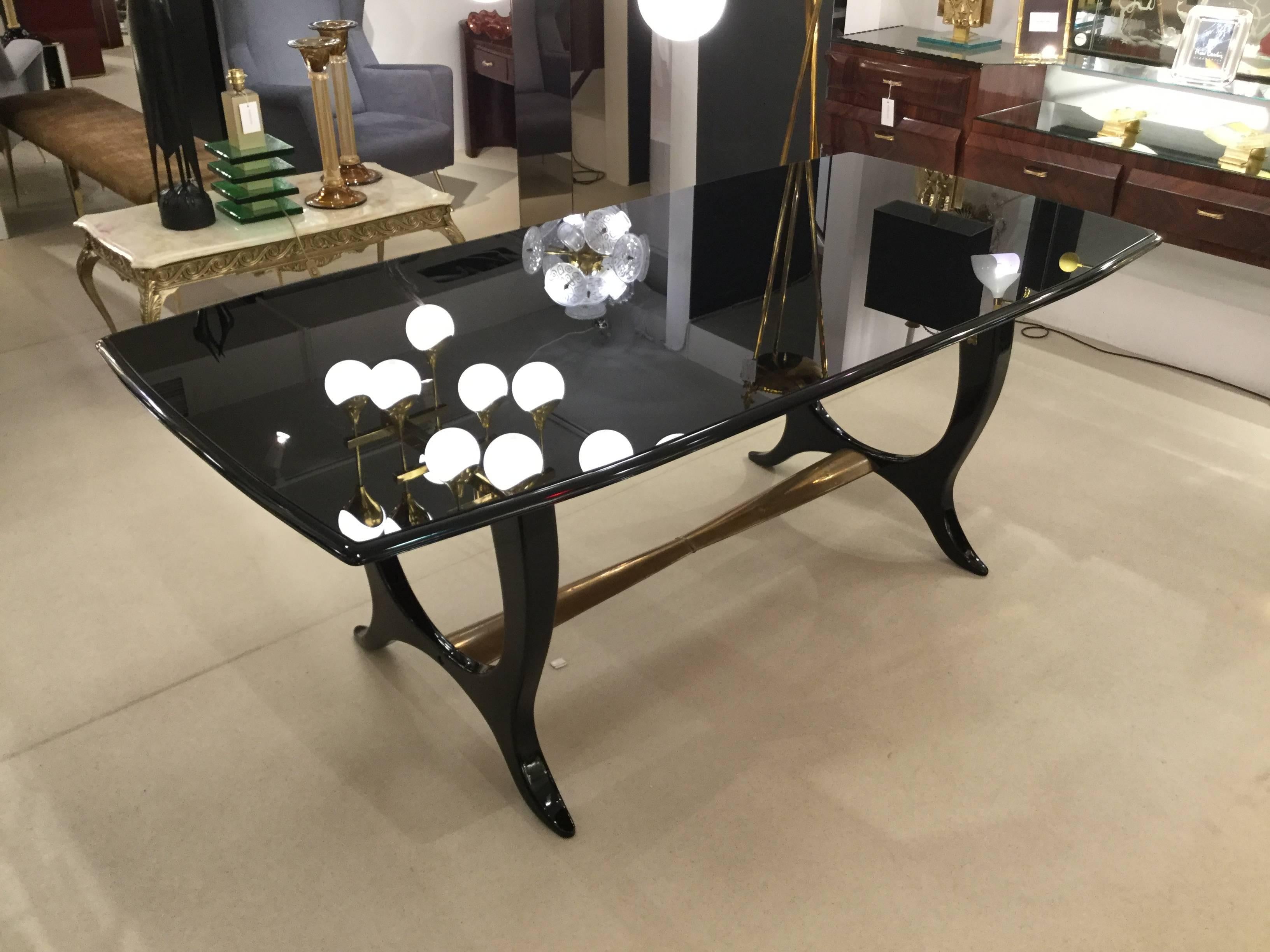 An Italian designed dining table could make a great weighting desk in ebonized wood glass top with hammered brass footrest attributed to Paolo Buffa