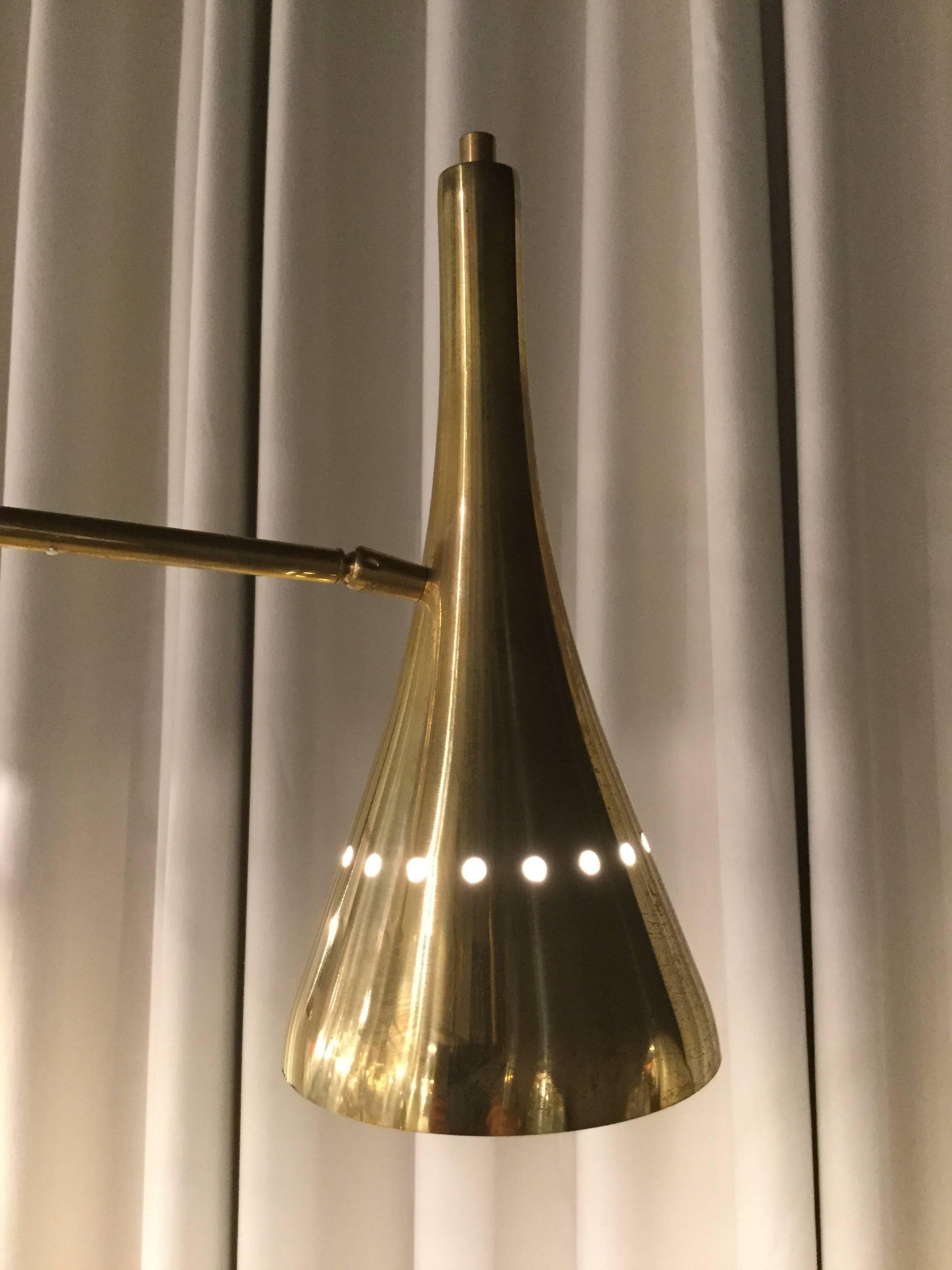 An Italian designed chandelier in brass with six arms with directional shades.