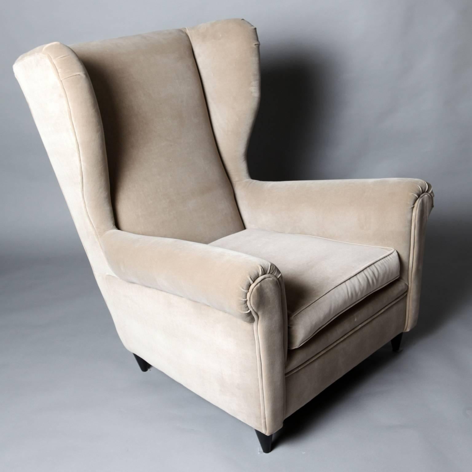 A pair of reupholstered armchairs in the style of Gio Ponti, circa 1950.