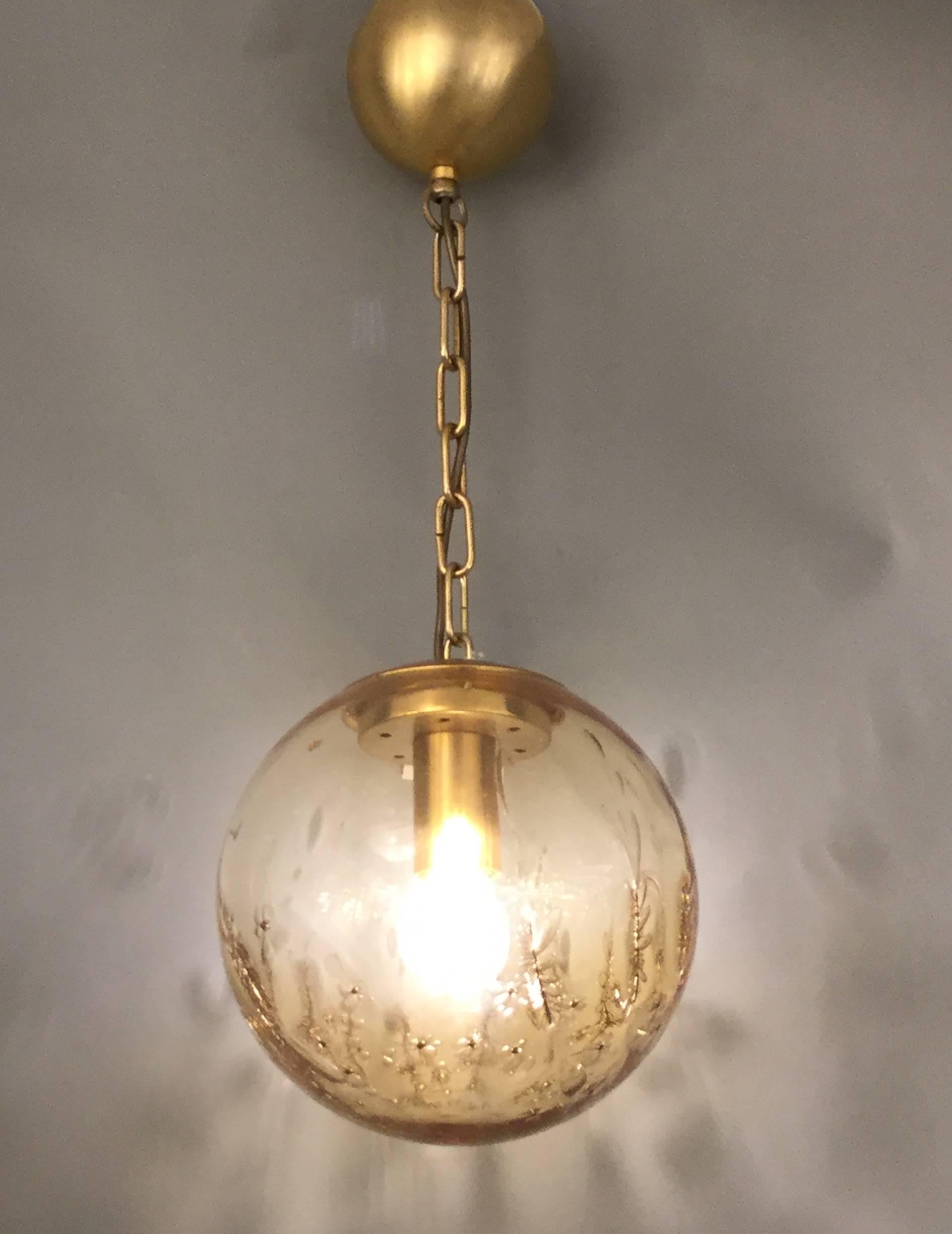 An Italian designed spherical Murano glass pendant with brass hardware signed by La Murrina.