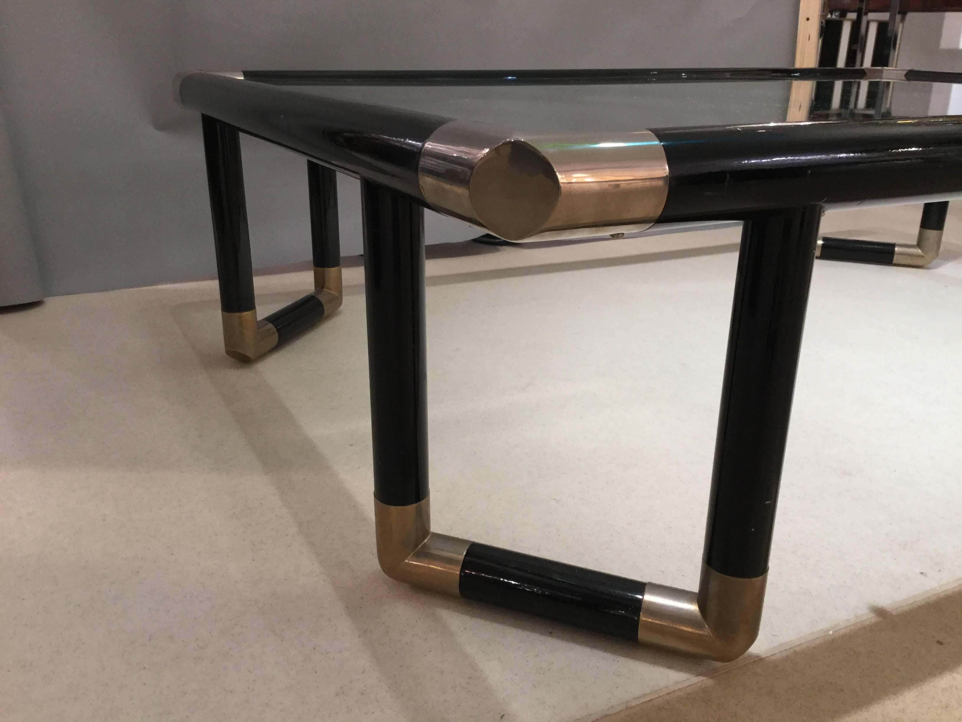 1970 Italian coffee table in black lacquered wood with nickel-plated details and glass top.