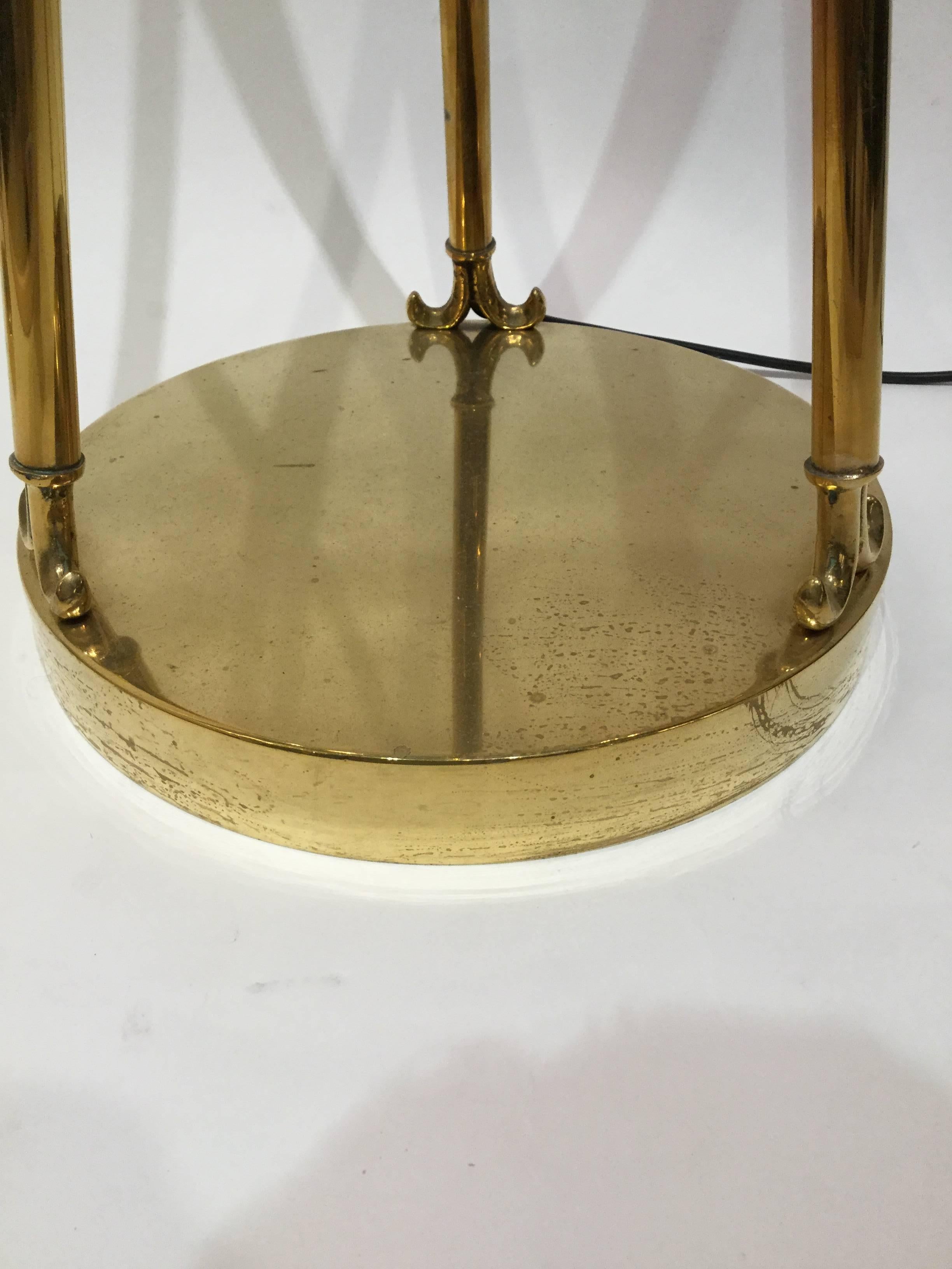 Massive pair of brass floor lamps. Circular base with slender profile, circular shade Classic design. Newly rewired.