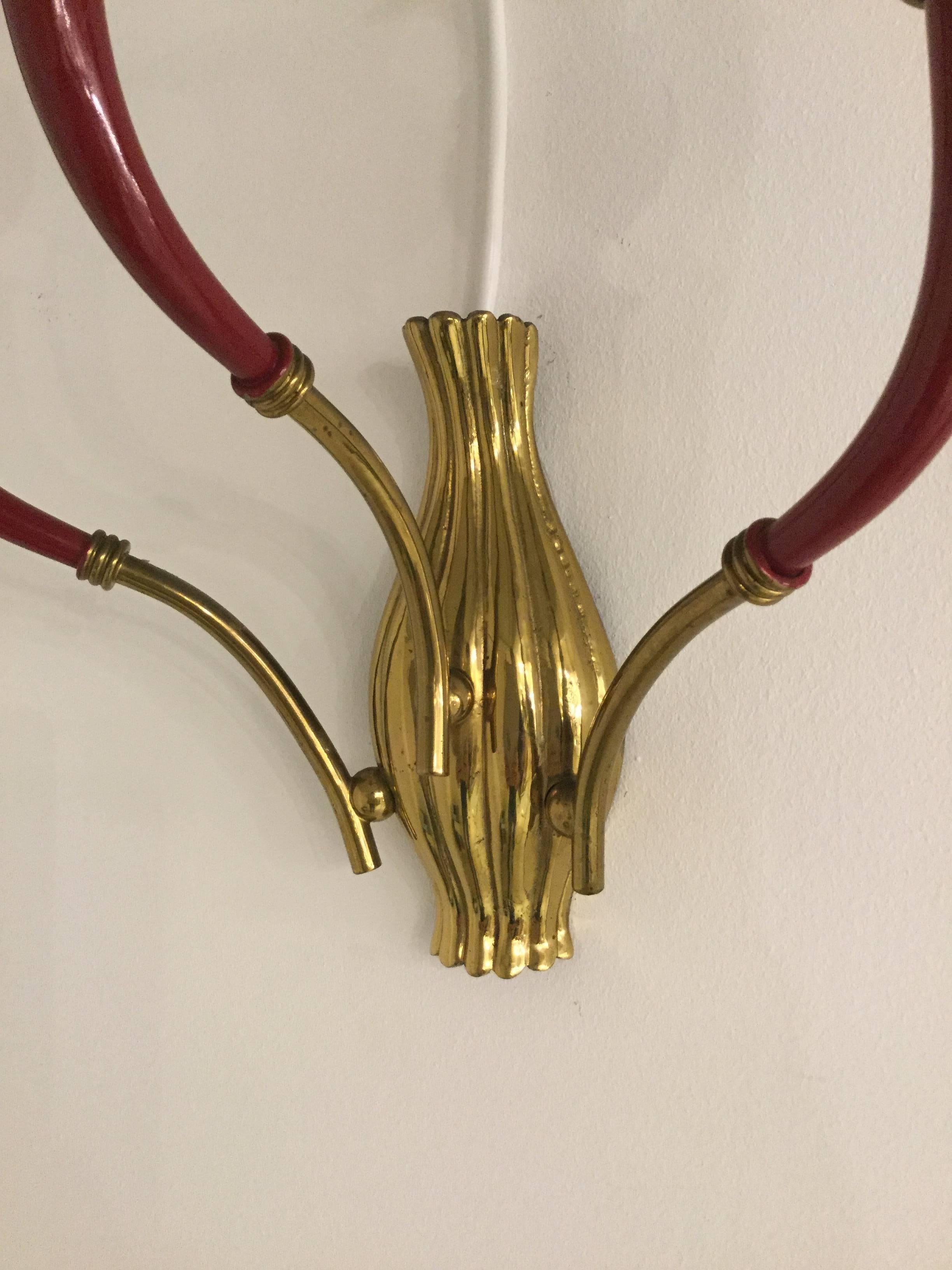 Outstanding pair of Italian sconces in brass and burgundy fitting.