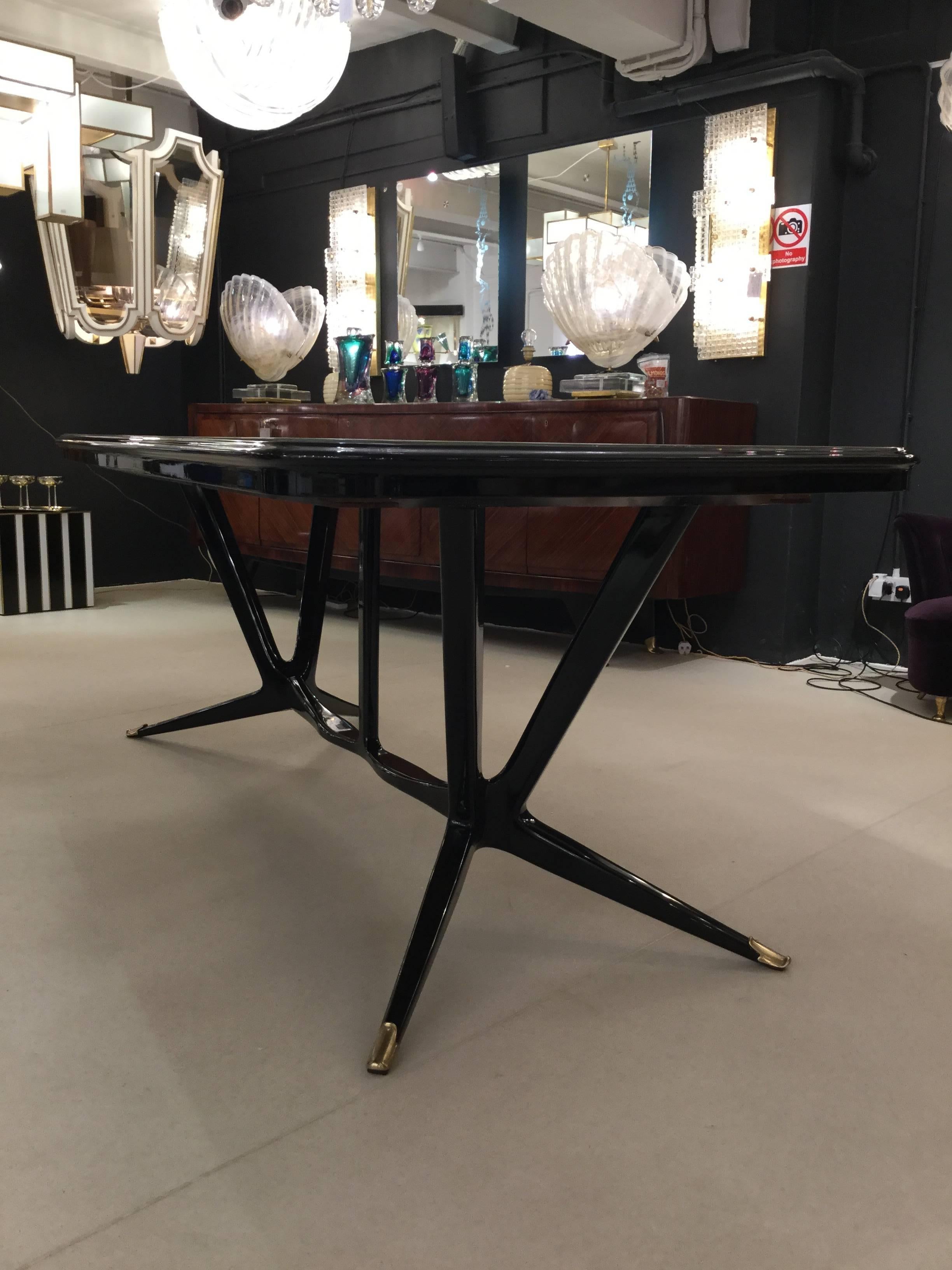 Outstanding dining room table, Italy, circa 1950, black lacquered wood, grey glass top, organic shaped legs, perfectly restored.