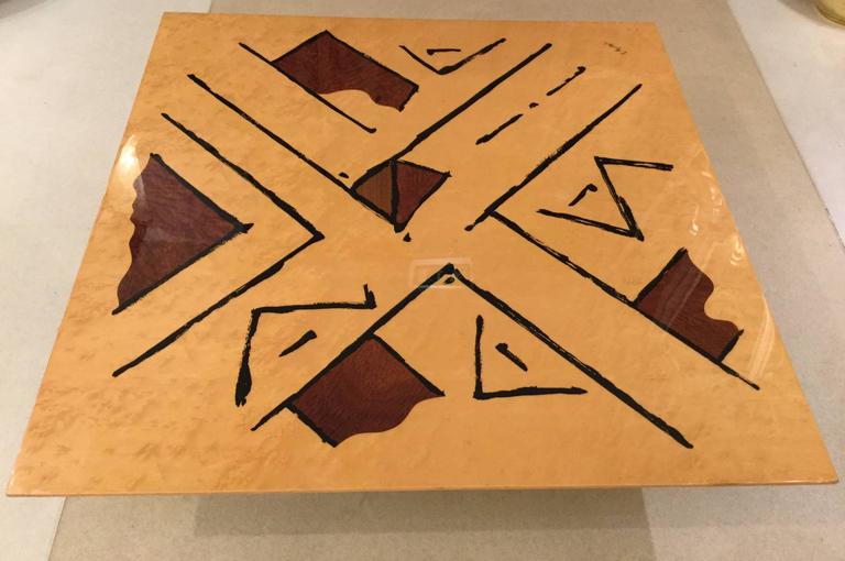 A hand-painted coffee table with geometrical drawings in black, beige and brown, signed by the artist. 1960s