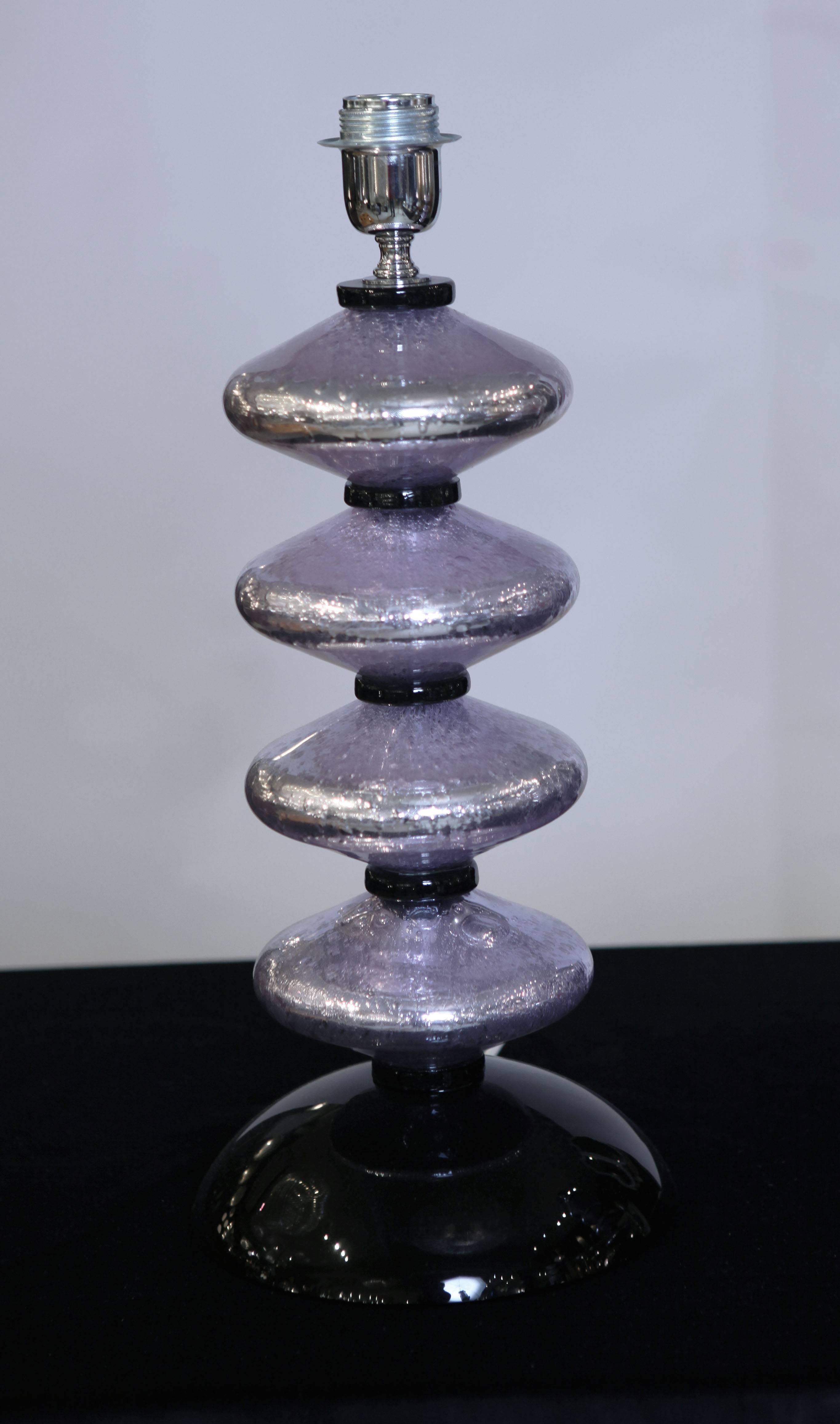 A pair of Italian lamps in amethyst mirrored glass with a black glass base and four sections divided by black glass rings. 
In excellent conditions.