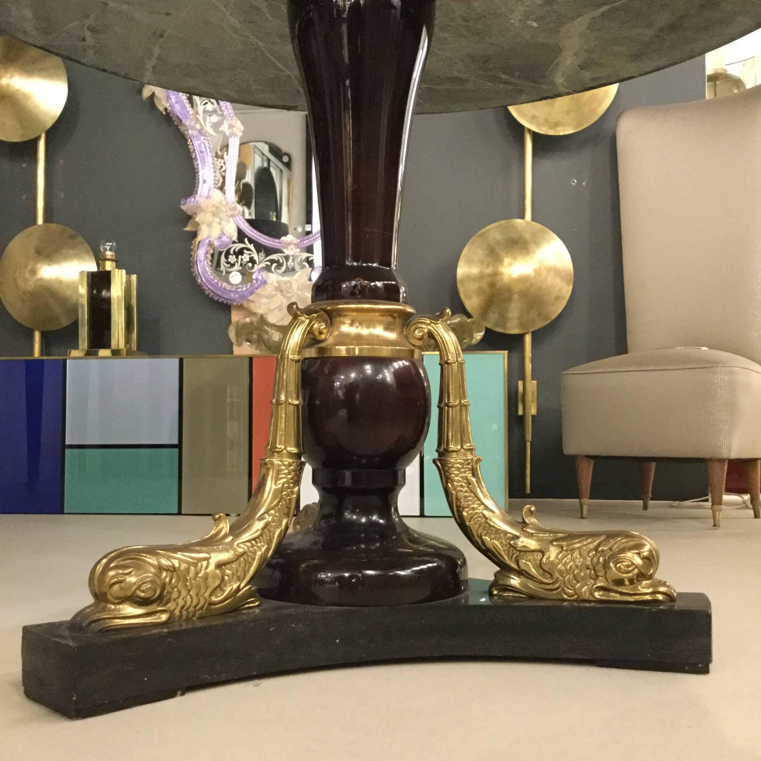 This beautiful table is characterised by a tripod wood base adorned with three bronze dolphins. The top is in green marble.
In excellent vintage condition.
 
