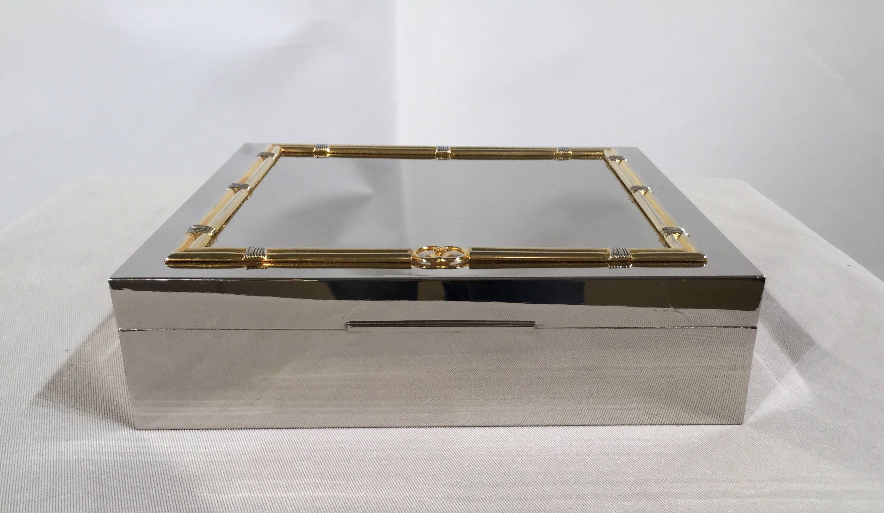 A beautiful, Gucci decorative box. Silver and brass-plated, with a faux-bamboo border along the top. In excellent conditions.

 
