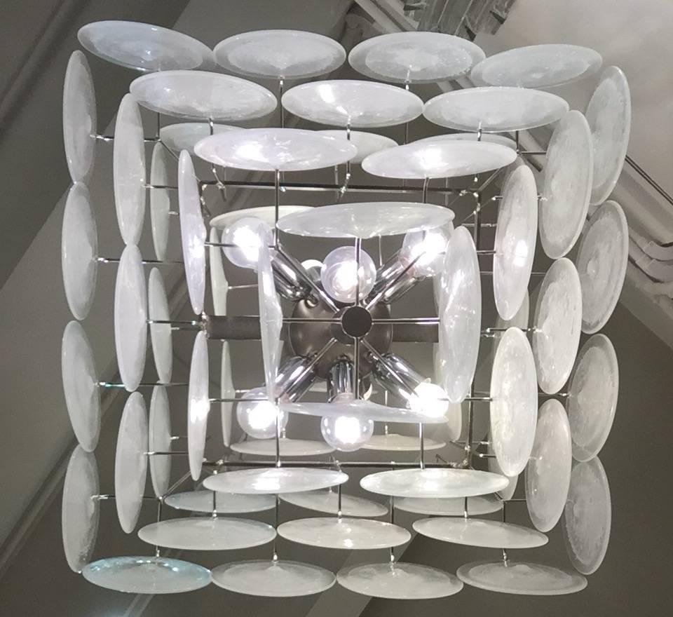 A beautiful chandelier made of a metal structure consisting of seven level with an increasingly number of round Venetian glass pieces.
           