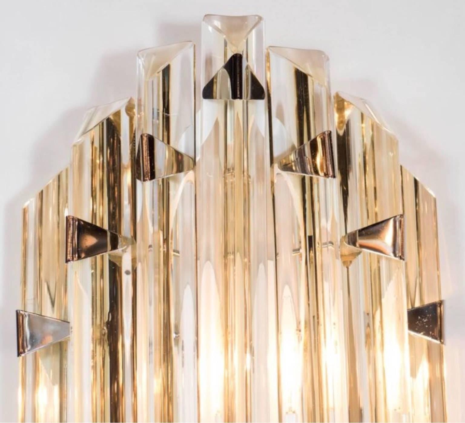 Two beautiful pairs of Mid-Century Modernist sconces in the style of Venini.  Amber Murano glass 'triedri' rods with polished nickel triangular details and back-plate.


  