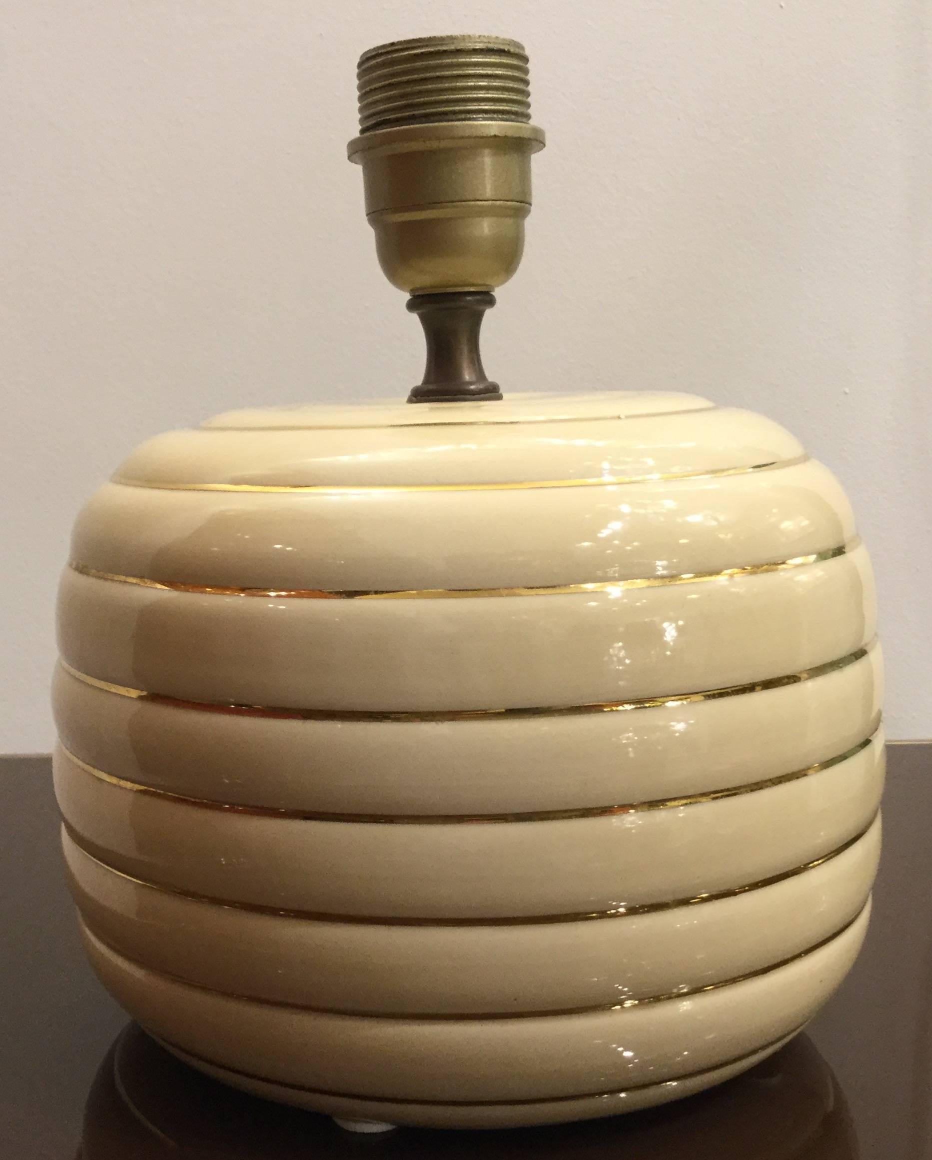 A pair of Italian designed table lamps hand crafted in Ivory ceramic with 24 carat gold band detailing design style of Tommaso Barbi, circa 1960.