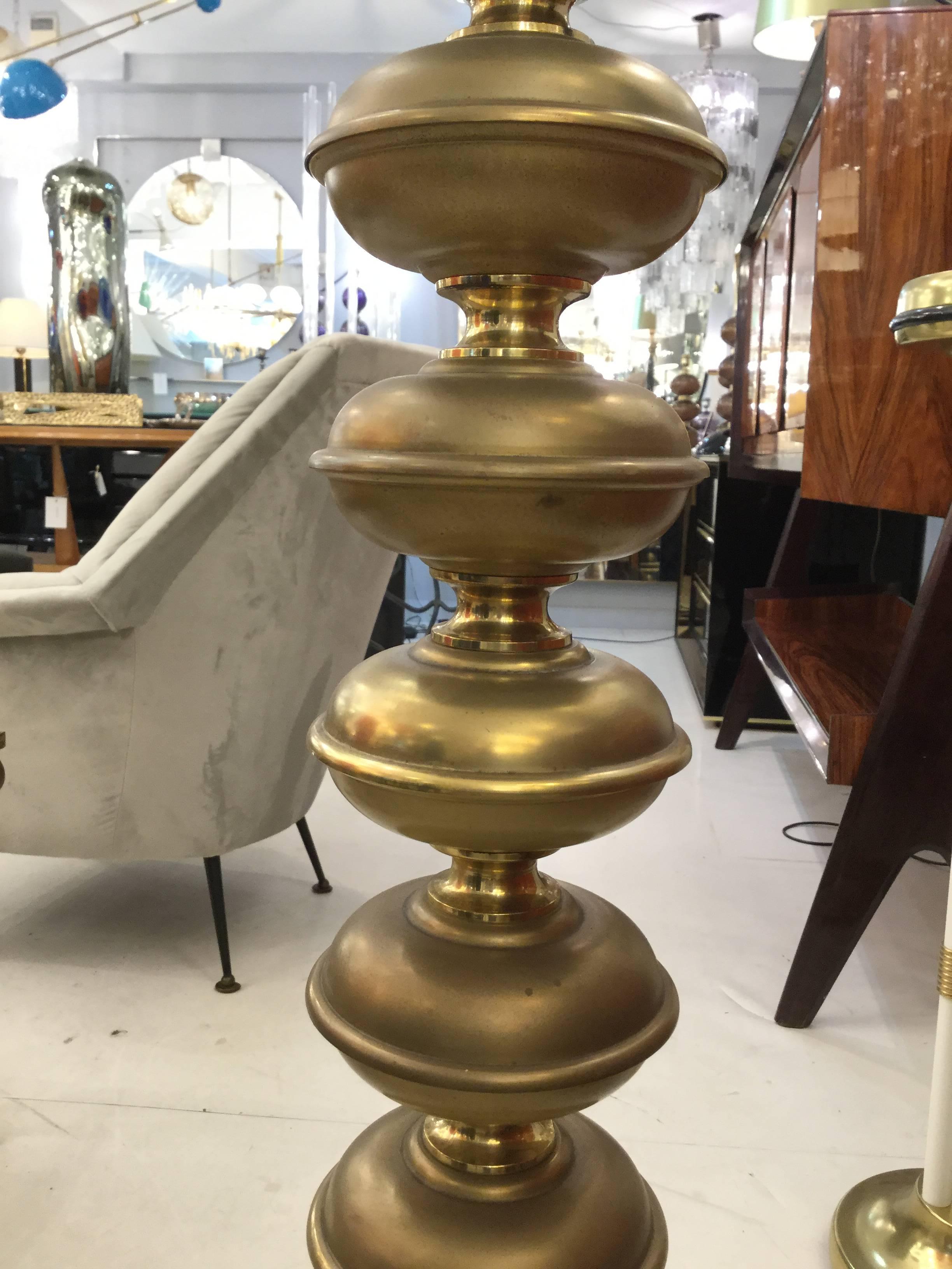 A French designed decorative salon floor lamp in spun brass with original shade attributed to Masion Jansen, circa 1960.