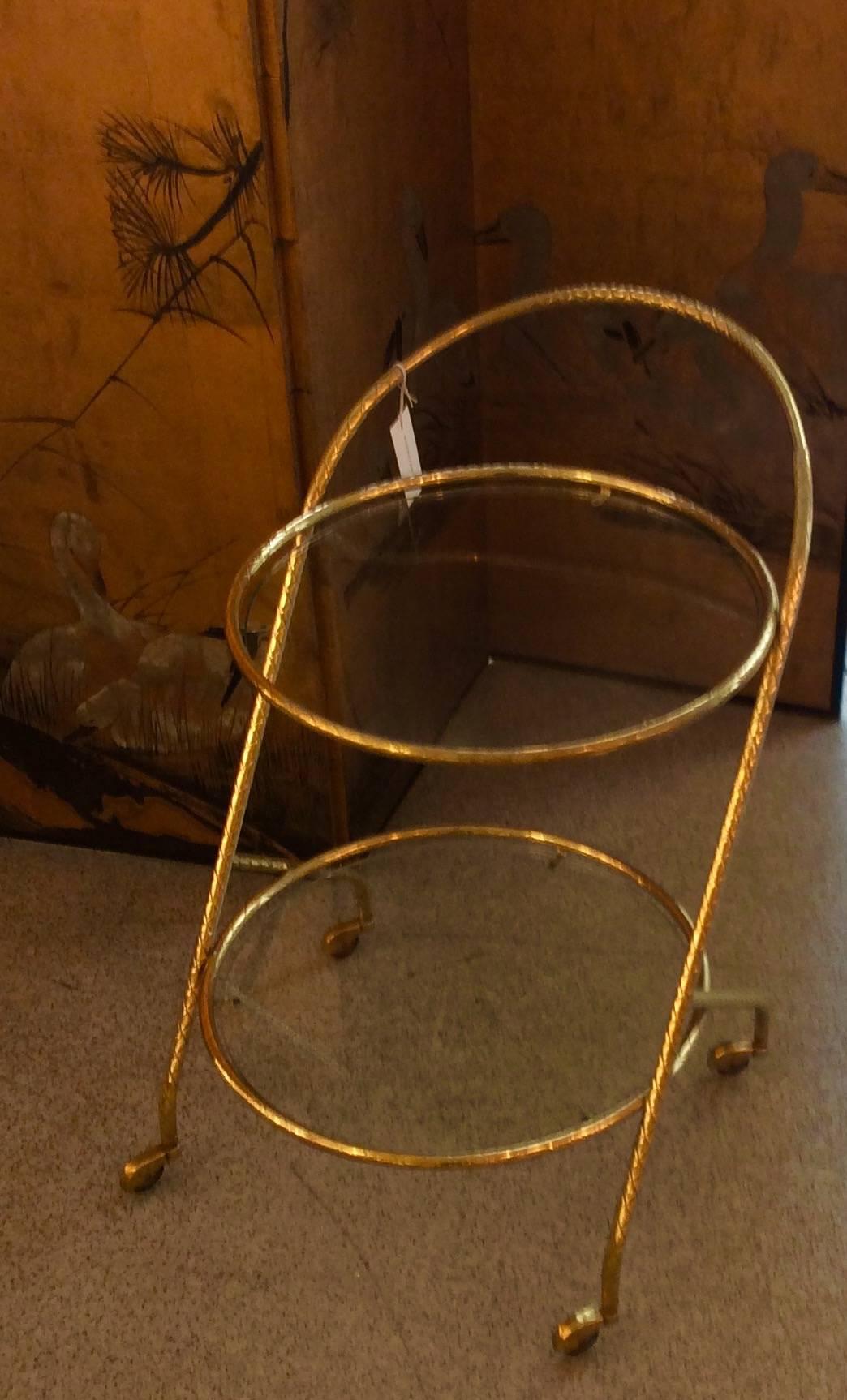 An Italian designed bar cart two circular tiers in brass faux bamboo circa 1960.