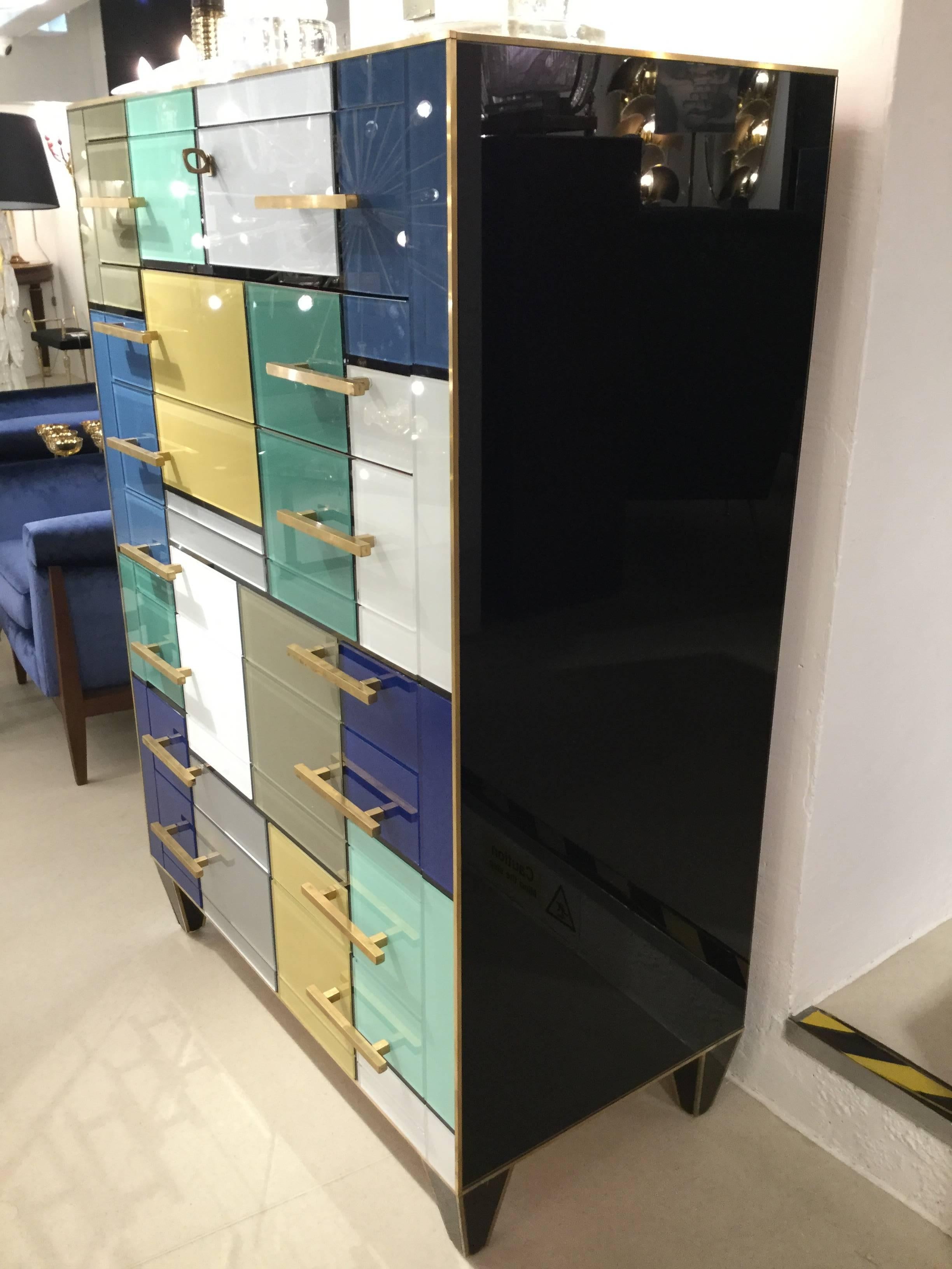 An Italian Venitian designed 7 day chest of drawers in multicolour glass profiled in brass also brass handles. Like an art installation style of Mondrian, circa 1970.