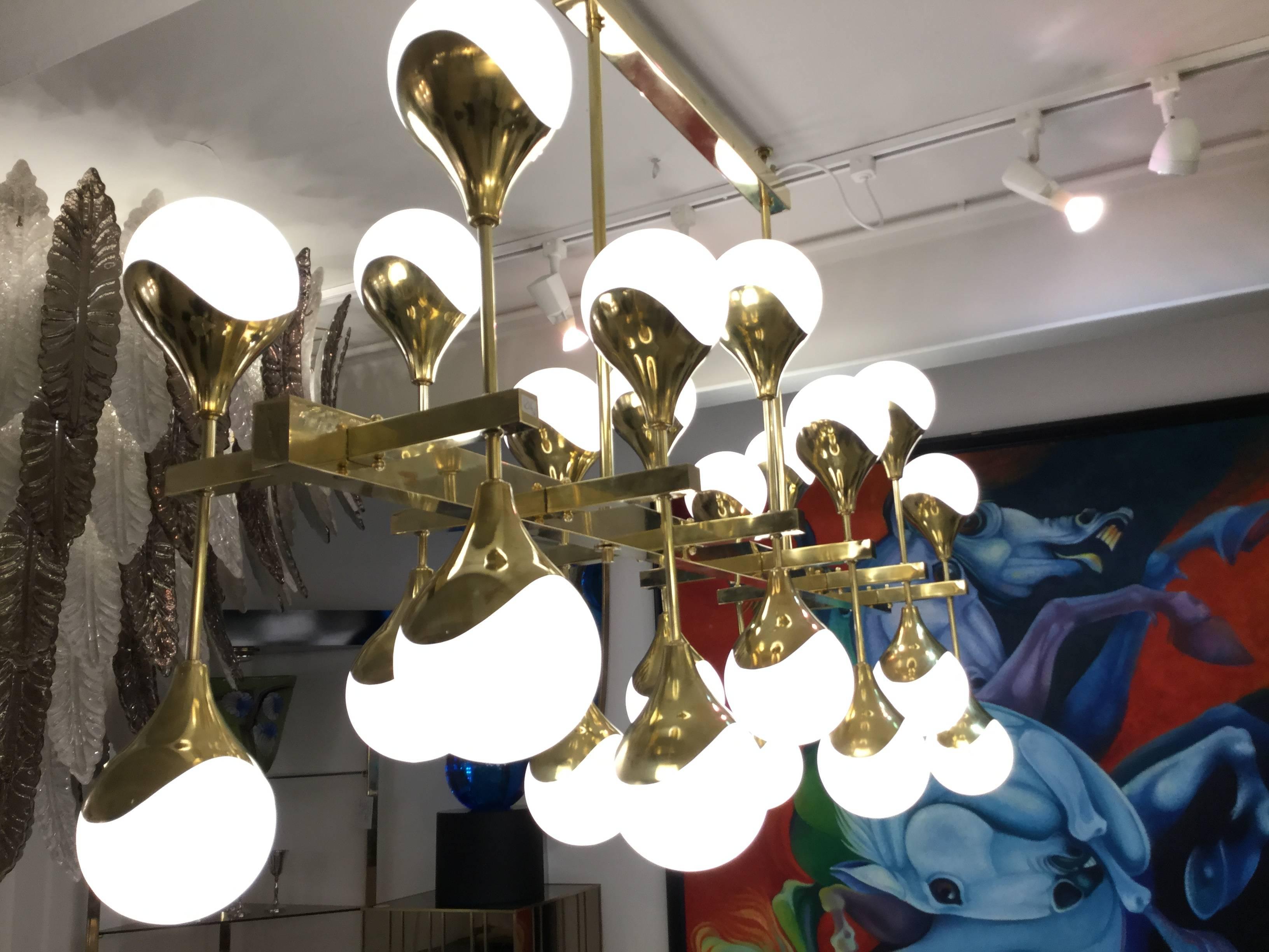 An Italian designed sculptural chandelier in brass with 24 opaline glass shades rewired.