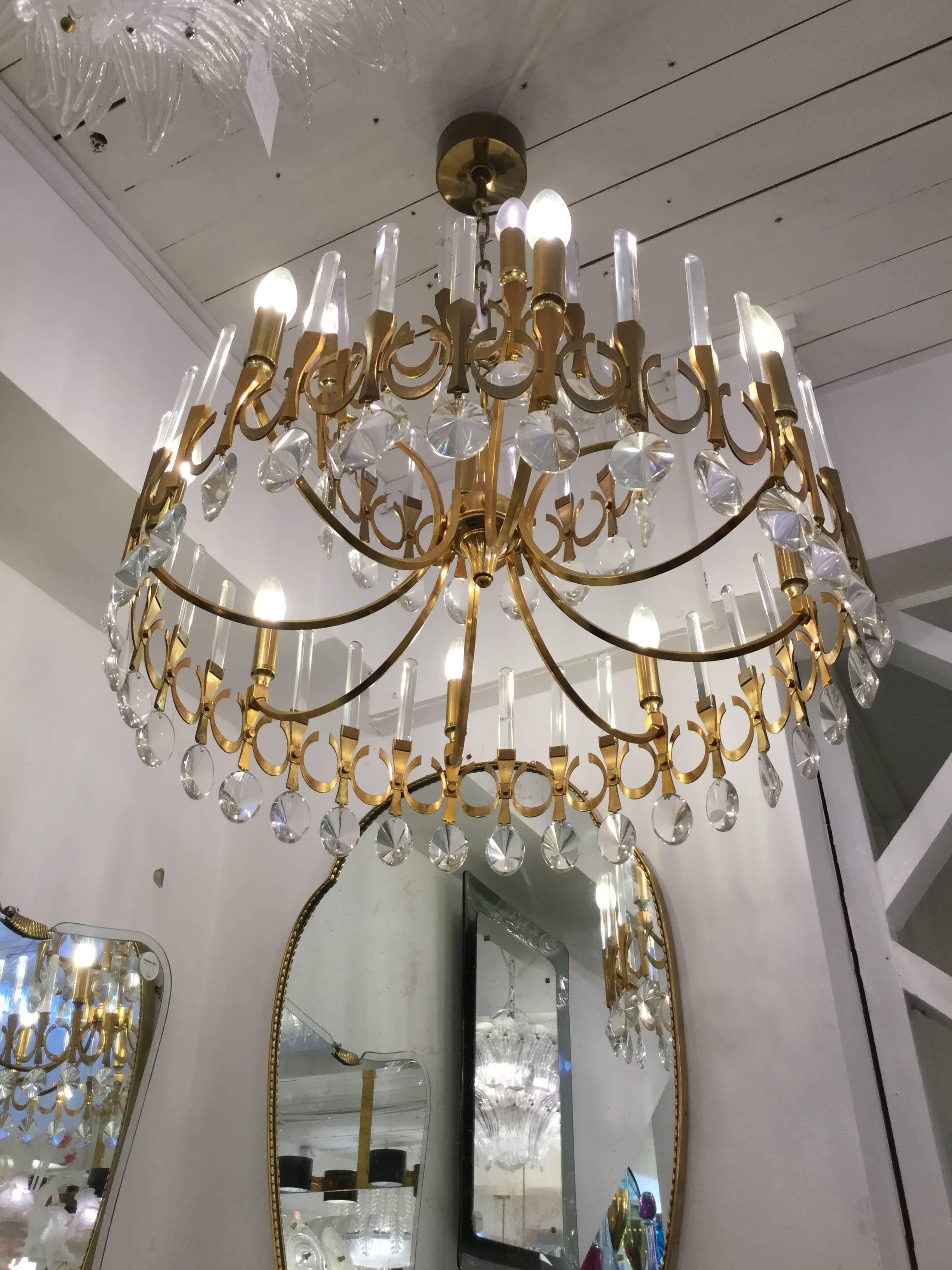 An Italian designed chandelier in brass with crystal drops two-tier, circa 1960.