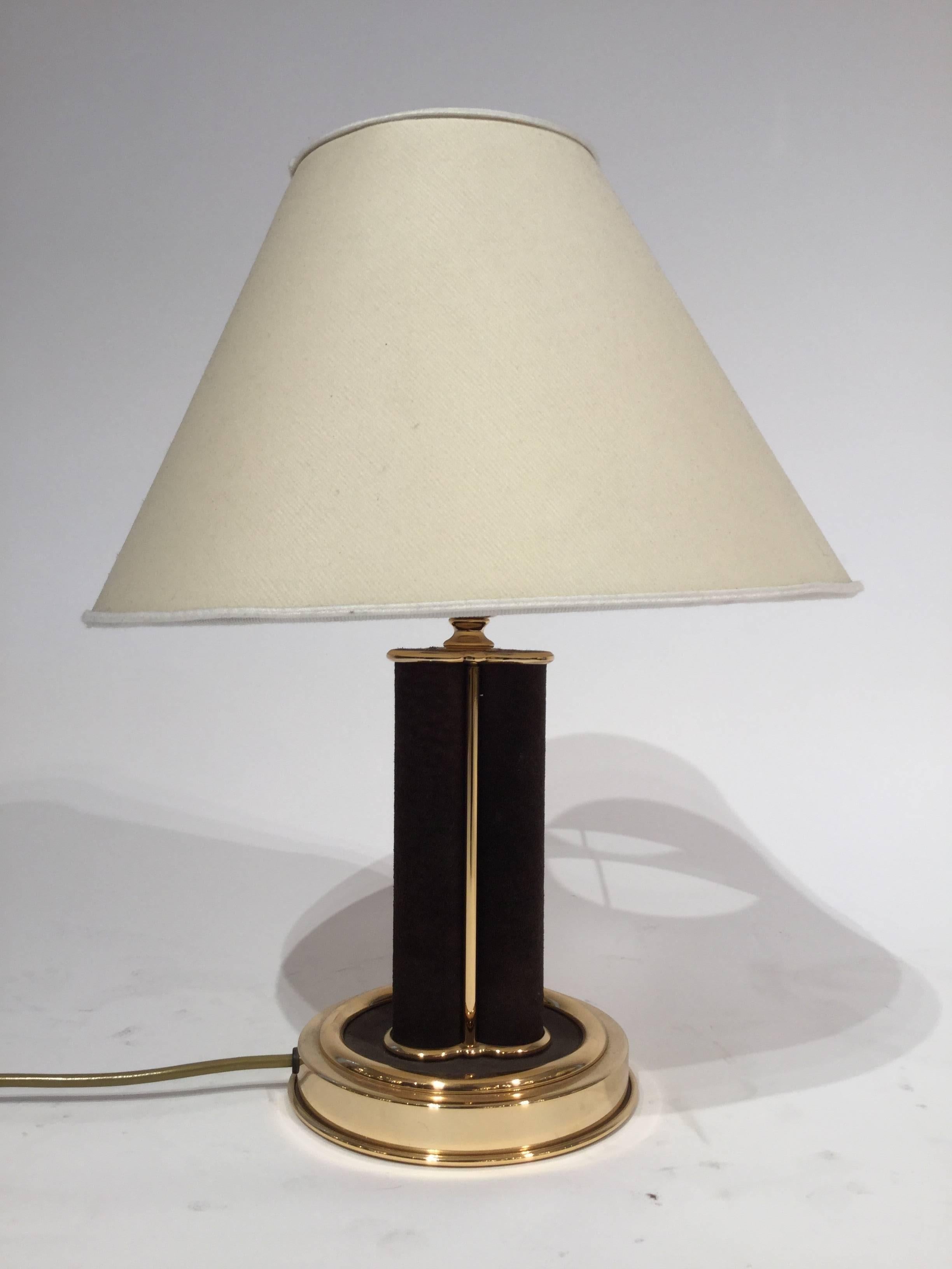 A pair of Italian designed table lamps in suede and brass, circa 1960.