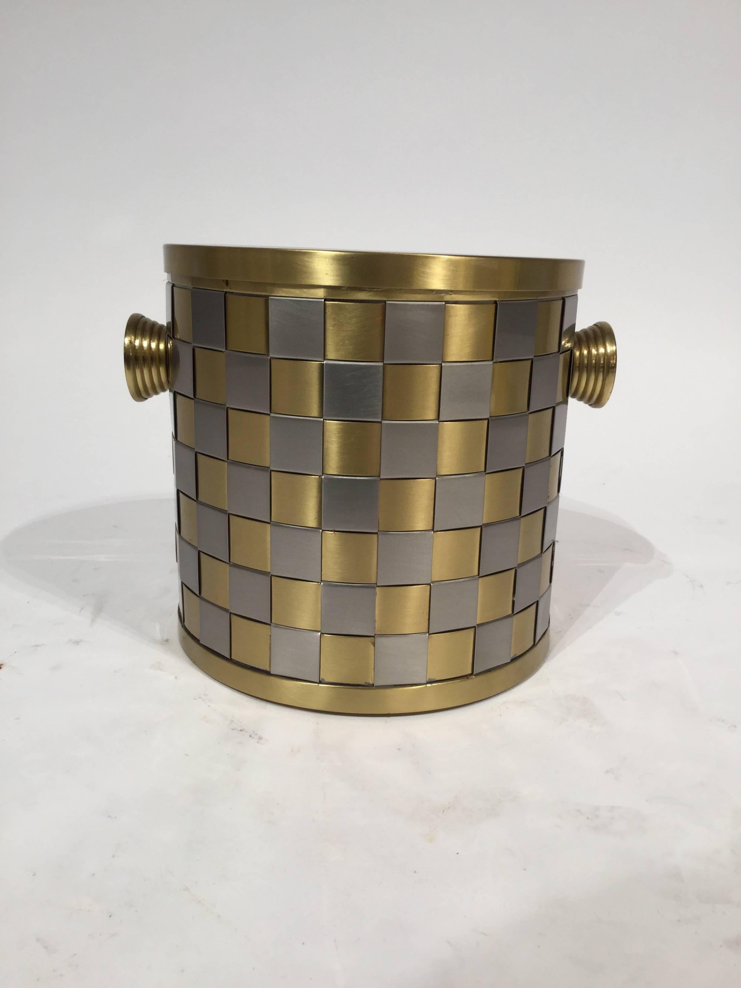 An Italian designed ice bucket in interwoven brass and brushed steel squares, circa 1970.