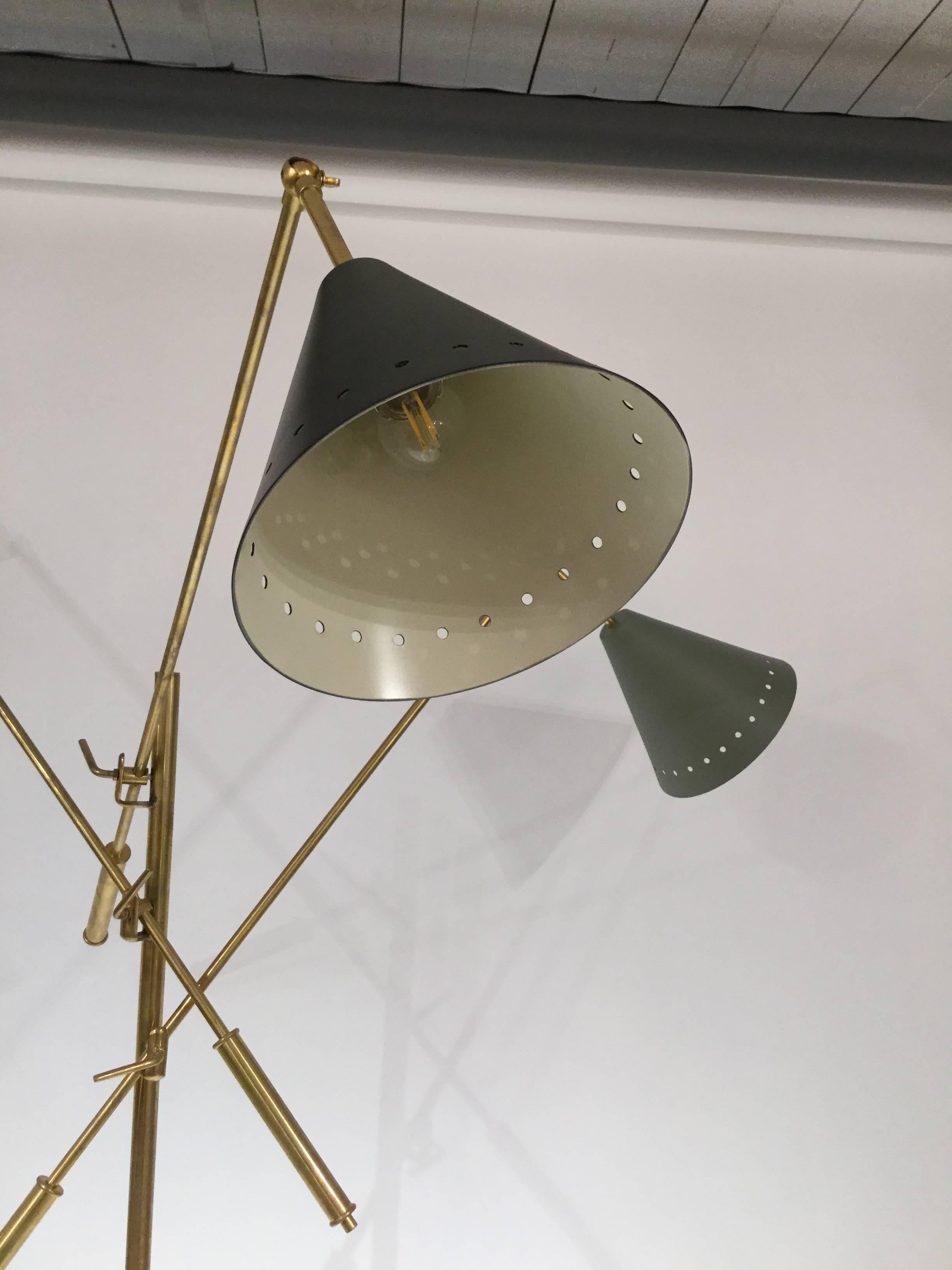  Italian designed modernist  floor lamps in brass on tripod legs with painted shades in black grey and ivory.