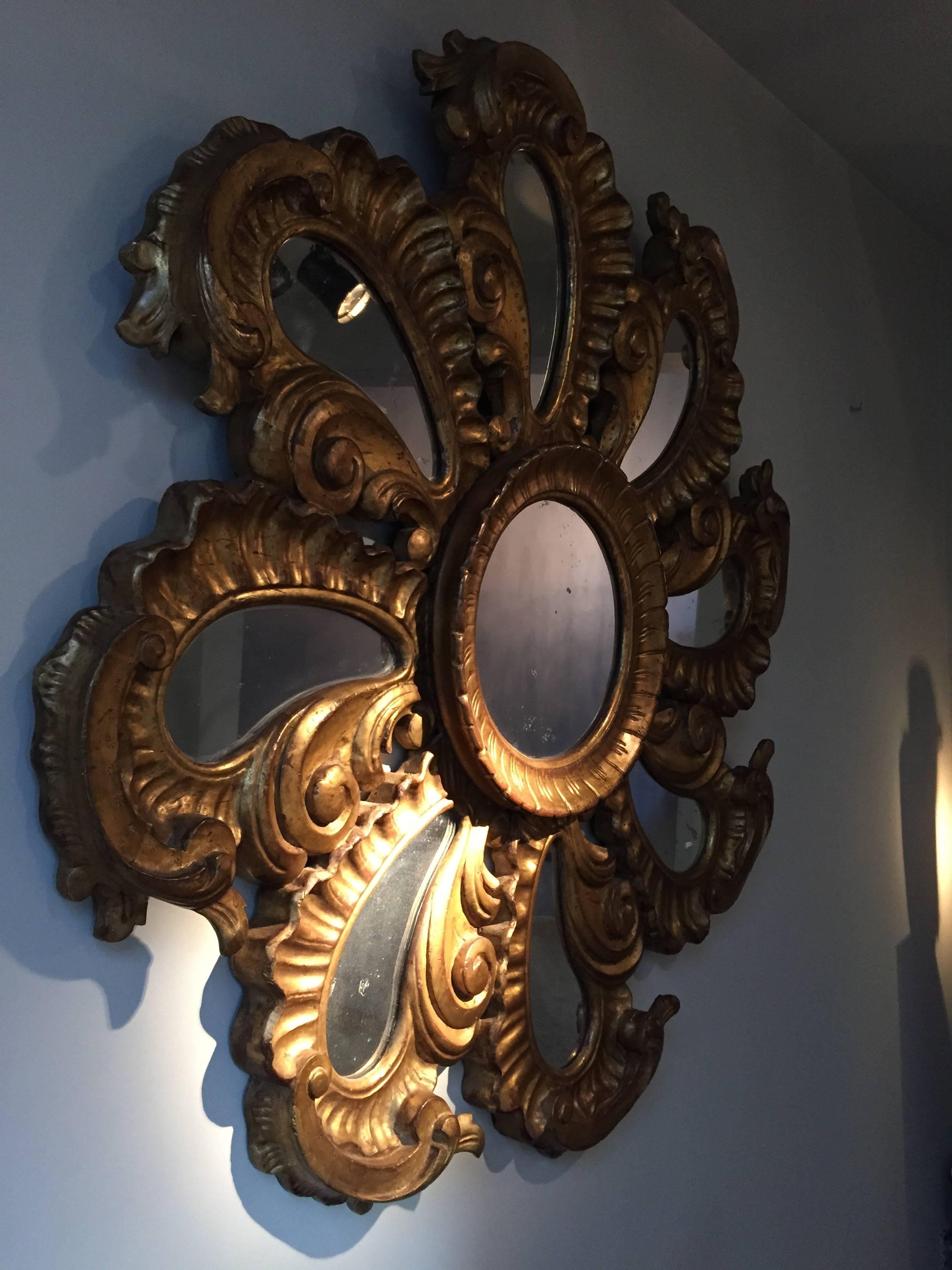 Almost identical pair of Italian gilded wood mirrors.