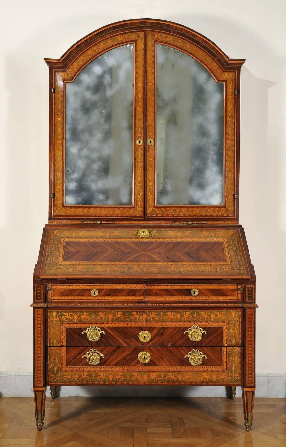 This couple of furniture is made of Louis XVI commode and trumeau. The first one is a commode with two drawers plus one, top drawer can be opened as a desk and is concealing six drawers and a flap with a mirror. Veneer in purple wood richly inlaid