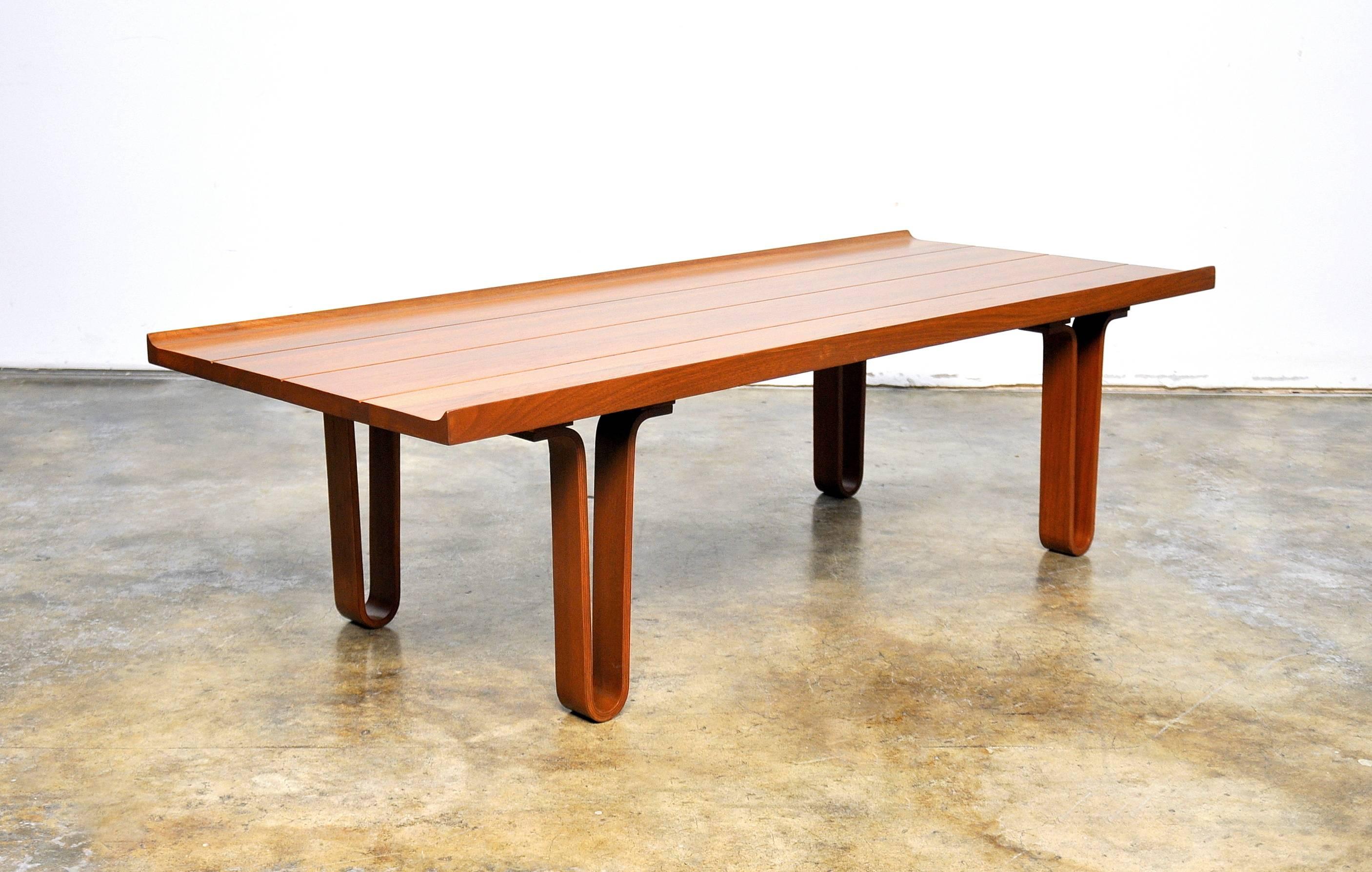 Mid-Century Modern bentwood, walnut, cocktail table bench with masterfully crafted attention to detail. The seamless joinery of solid walnut creates rich flowing grain patterns on the top. The table is sleekly styled, and its high-end craftsmanship