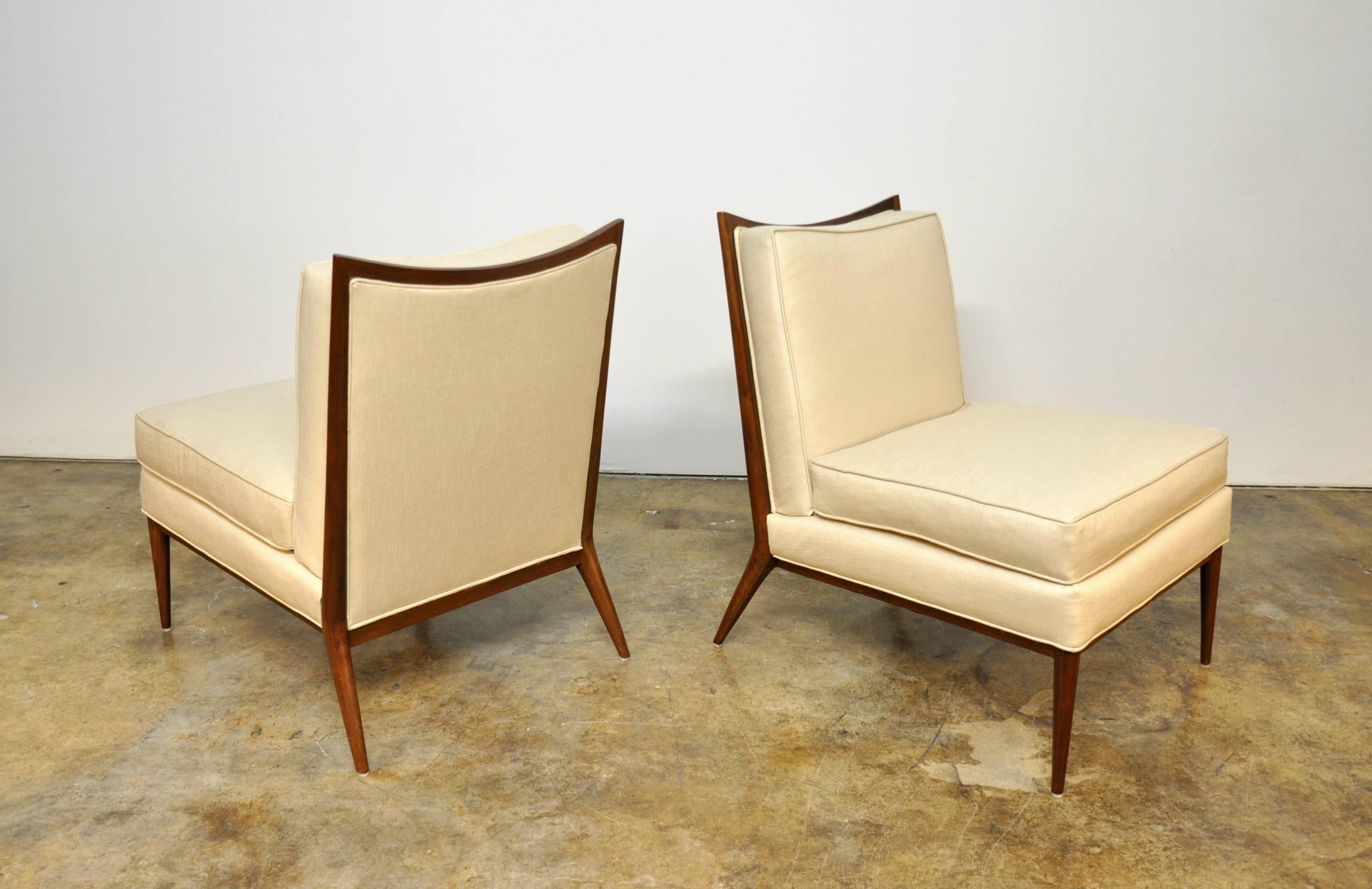 Exquisite pair of Mid-Century Modern slipper lounge chairs from the highly esteemed Directional collection, dating from the 1950s. The refinished chairs have been recovered in stunning soft champagne Kravet upholstery. The beautifully sculpted